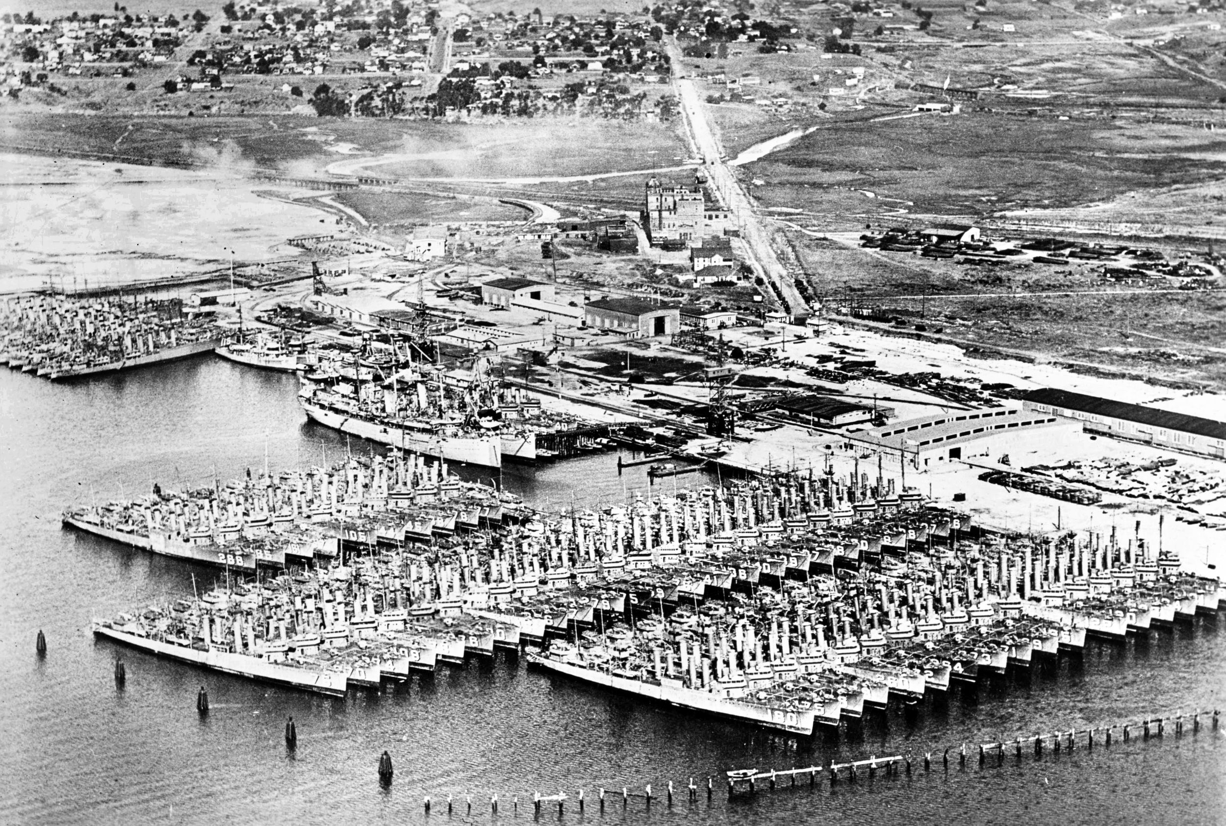 At the San Diego Destroyer Base in California, some 65 destroyers are tied up at “Red Lead Row.” The Zane was decommissioned at San Diego in February 1923, and remained here for seven years. She spent the 1930s as a destroyer with the 2nd Destroyer Flotilla. At the Pearl Harbor Navy Yard in 1940, she was reclassified as Destroyer Mine Sweeper 14 (DMS-14).