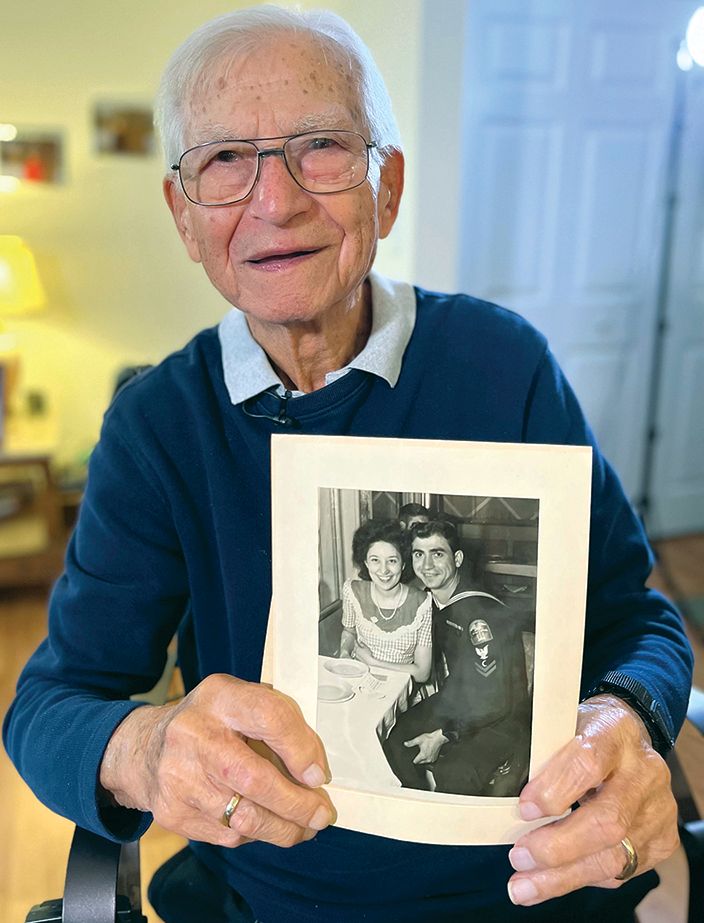 Julius Boreali, 100, holds a photo of him and late wife, Antonette, married August 19, 1945. He met her before joining the Coast Guard in 1942 and wrote letters to her while he was deployed overseas.