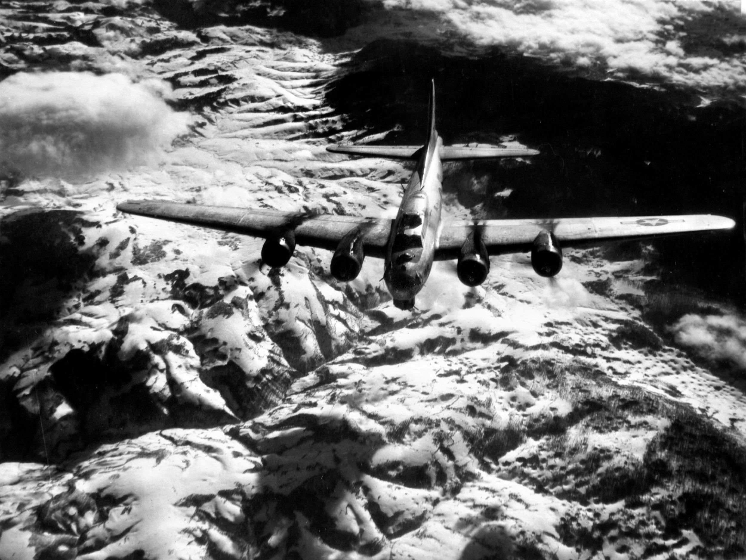 On another mission to Yugoslavia, a B-17 flies high over snow-capped mountains. Tucker said the only thing that kept crewmembers alive in the cold at high altitudes were oxygen and heated flight suits.