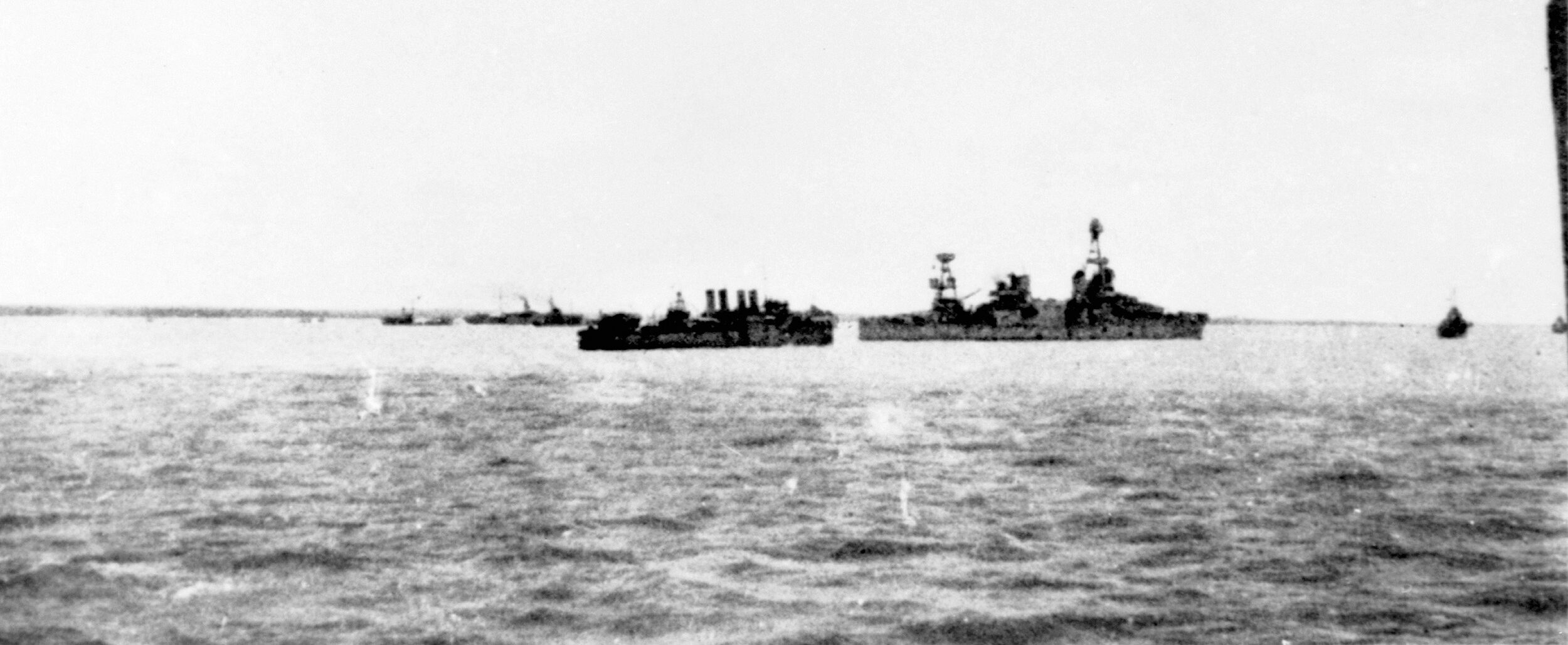 At anchor in the harbor of Darwin, Australia, the Australian cruiser Perth and the American cruiser Houston, both lost at the Battle of Sunda Strait, lie peacefully near the destroyers USS Preston and HMAS Platypus.
