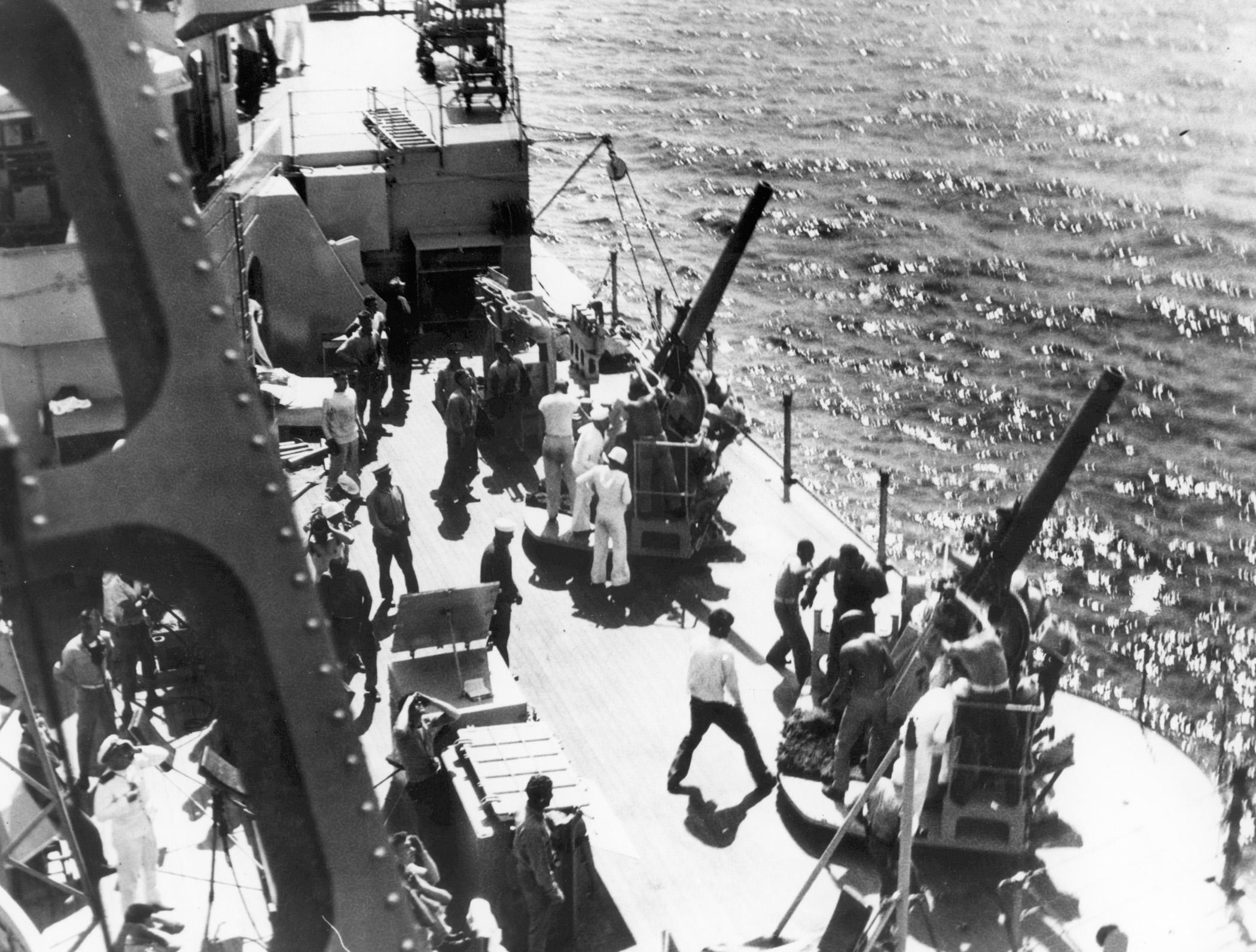 Crewmen of the USS Houston man antiaircraft guns while others scan the sky for planes off the Chinese coast near Chefoo in 1932-33.