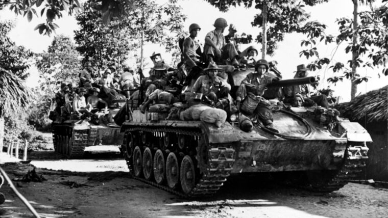 In January 1953, tracked armored vehicles support infantry movements during Operation Lorraine, the largest French offensive in Vietnam.