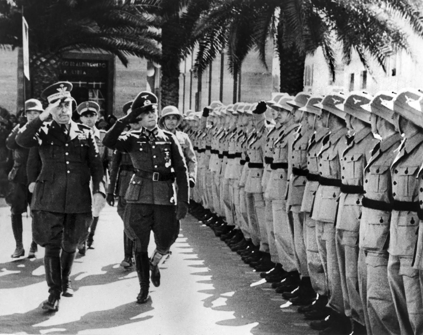 Italian General Italo Gariboldi, left, reviews German Afrika Korps troops with General Rommel in Tripoli. Adolf Hitler sent Rommel to North Africa to bolster Italian forces that had been routed by the British. Gariboldi was the commander of all Axis forces in North Africa, but Rommel disregarded his orders. 