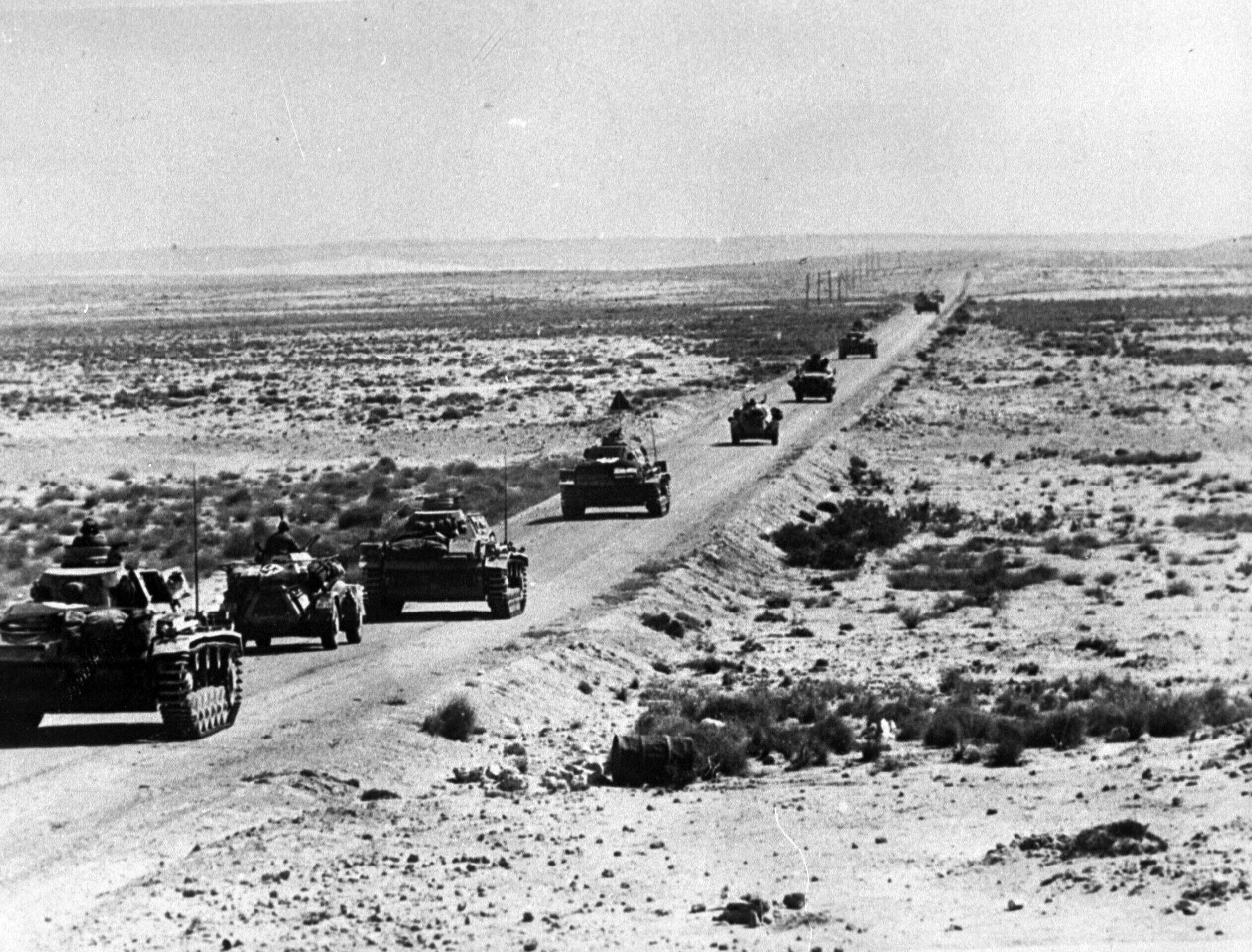 German Afrika Korps armored column advances across Libya in April, 1941. Most of the roads were unpaved “tracks” across the barren rocky landscape, subject to 90-mph sandstorms that clogged rifle breeches, buried supplies and equipment, and inflamed eyes. Gasoline and water shortages were also a constant problem.