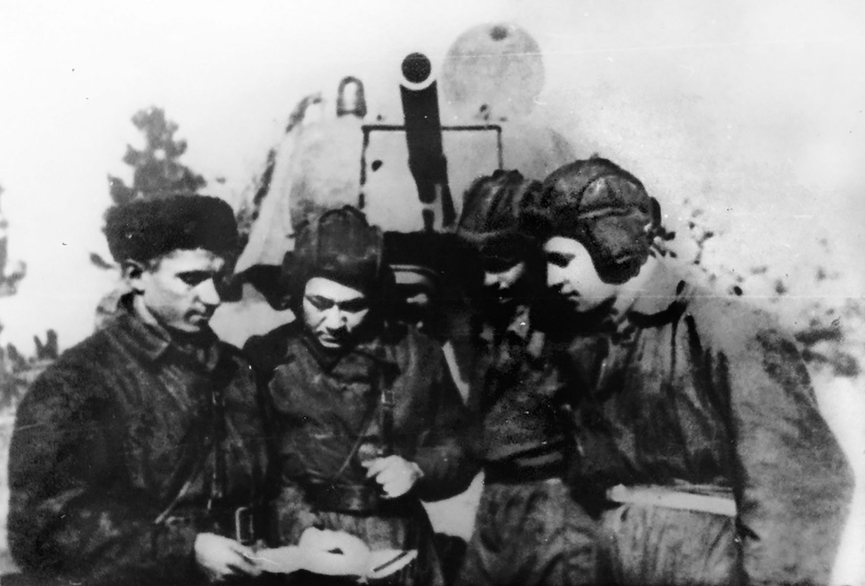 The crew of the  T-34 tank “Fighting Girlfriend.” Mariya kept a photograph of her husband with her in the driver's seat.
