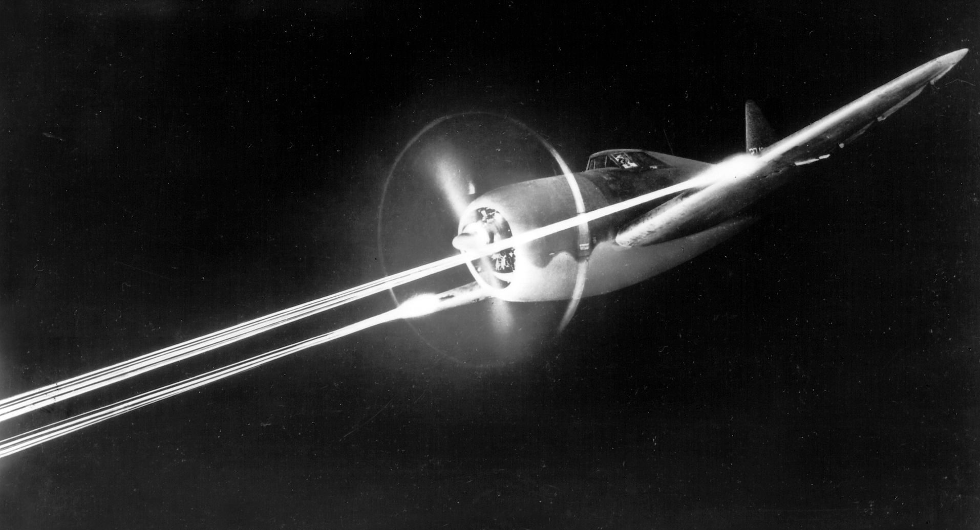 With .50 machine guns blazing, a P-47 takes part in night gunnery practice. Used as both a high-altitude escort fighter and a low-level fighter-bomber, the P-47 quickly gained a reputation for ruggedness. Its sturdy construction and air-cooled radial engine enabled the Thunderbolt to absorb severe battle damage and keep flying.