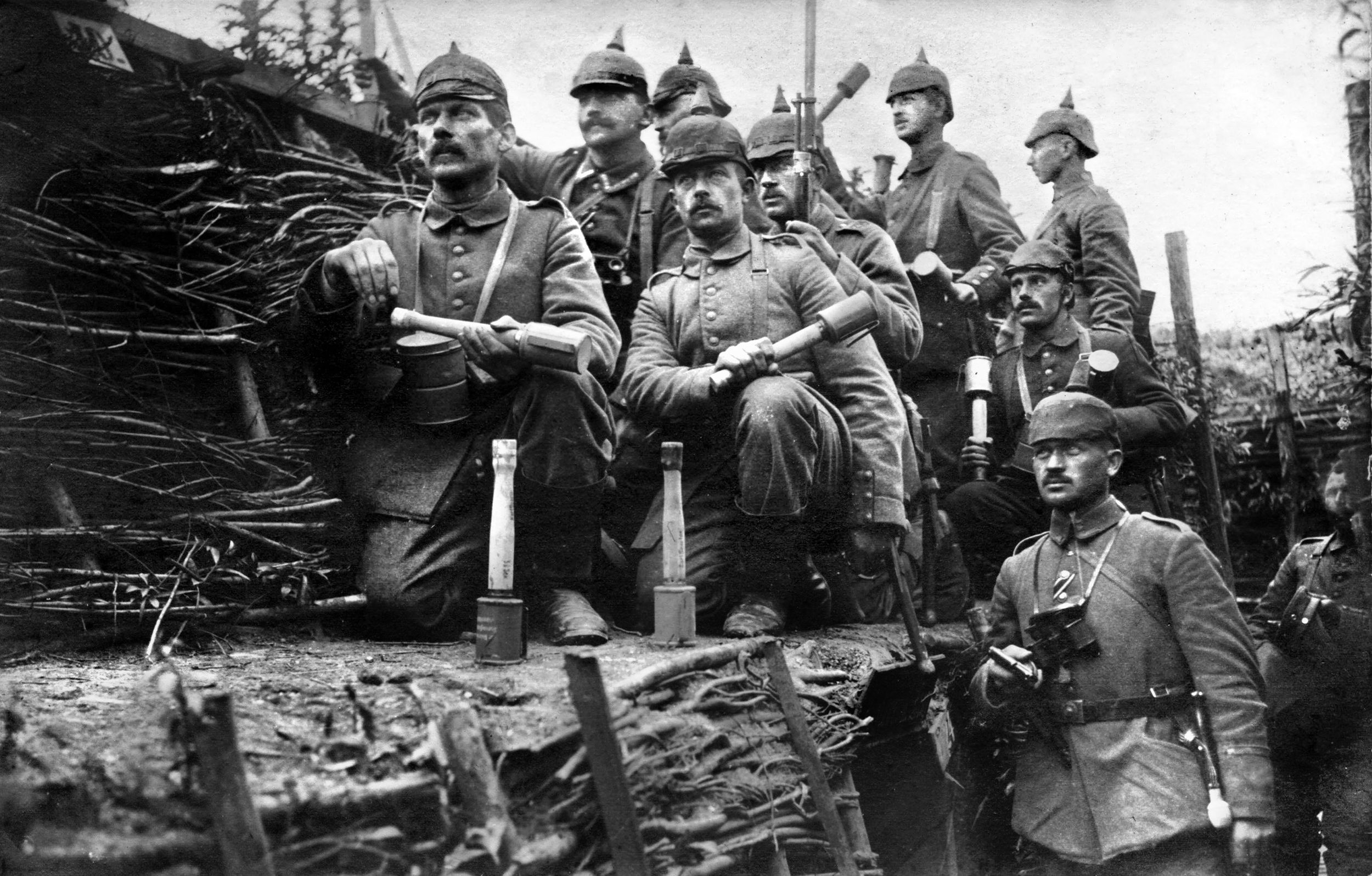 Germany infantry pose for a trench photo brandishing their “potato masher” grenades and “pickelhaube” leather helmets. The German “stick” style grenade was capable of being thrown somewhat further than the British “Mills bomb.” The pickelhaube, like British headgear, offered little protection and was replaced by the “Stahlhelm” steel helmet beginning in 1916. The French replaced their cloth “kepis” with their distinctive “Adrian” steel helmets beginning in July 1915. 