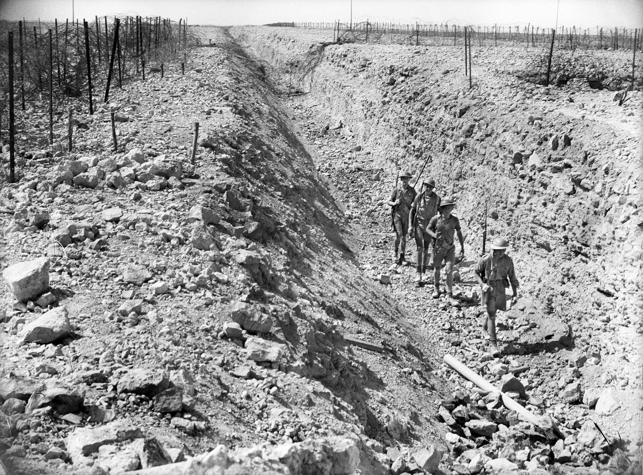 Australian troops march along the bottom of an antitank ditch, which the Italians had dug when they possessed Tobruk. 