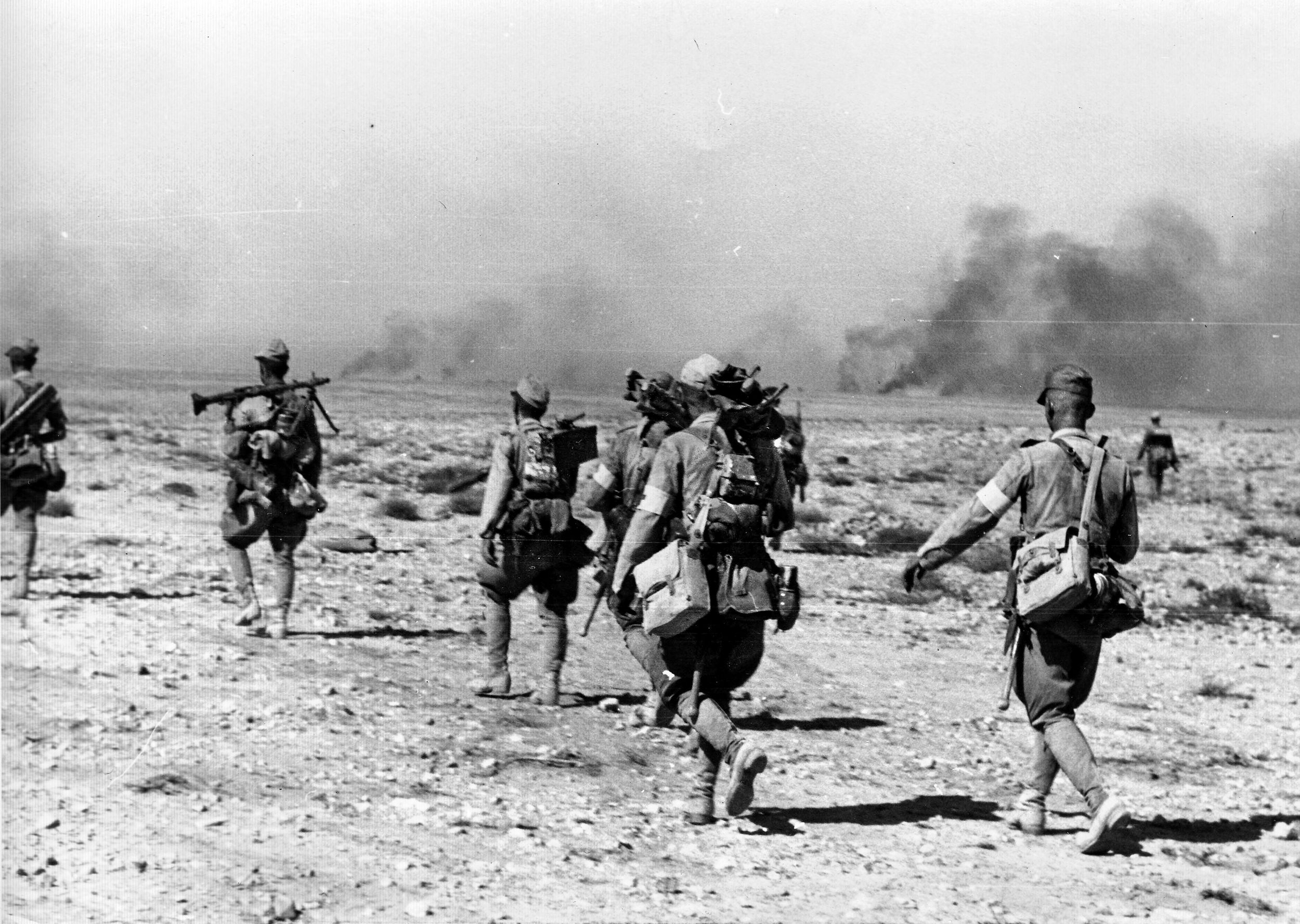 Afrika Korps infantry move across the desert, carrying an abundance of weapons and gear. Rommel’s demanding advance on the British caused frequent supply issues for his vehicles, as well as his soldiers.