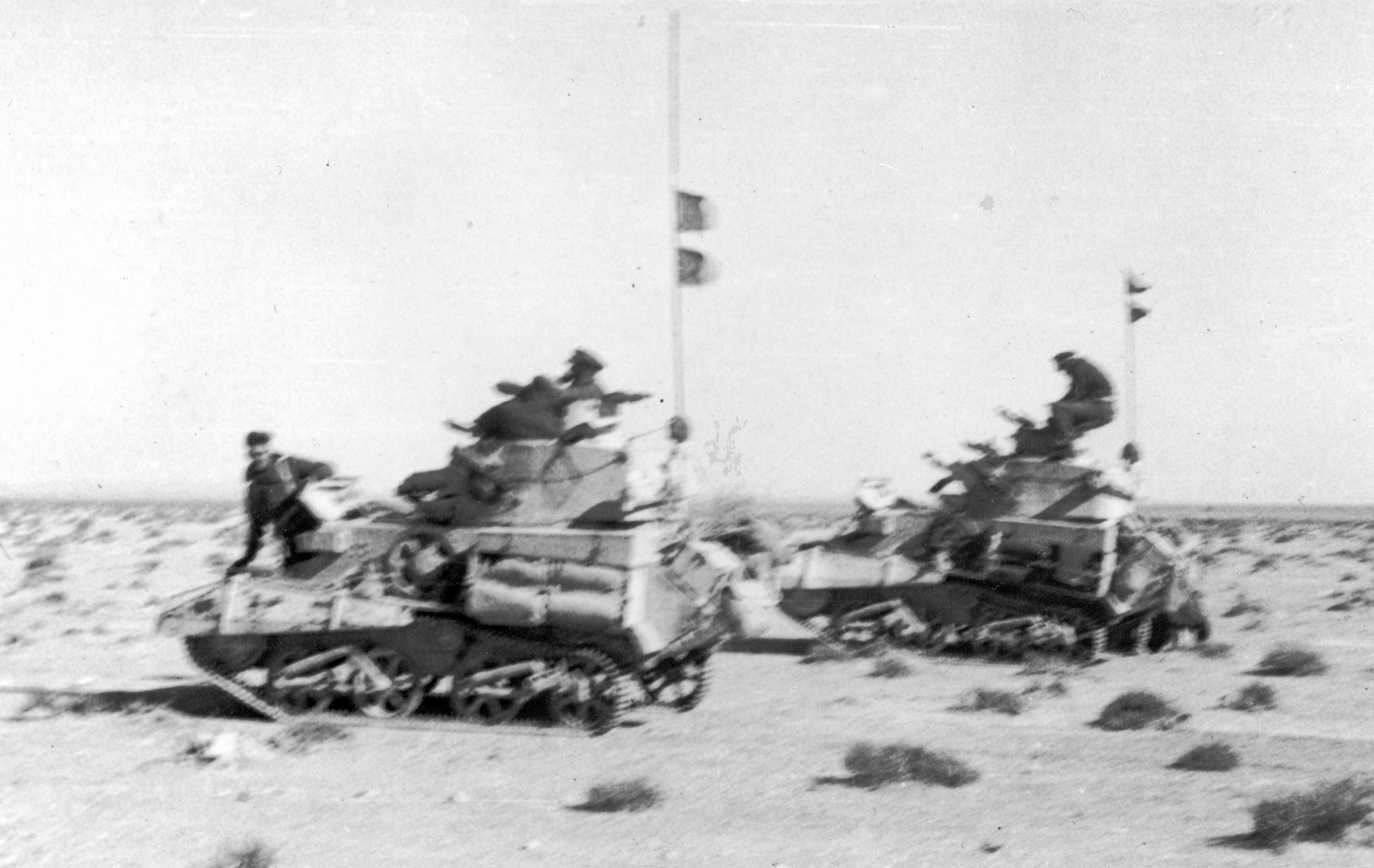 Speeding toward the action at Buq Buq, light tanks carry the commanding officer and adjutant of the British 4th Hussars on December 11, 1940.