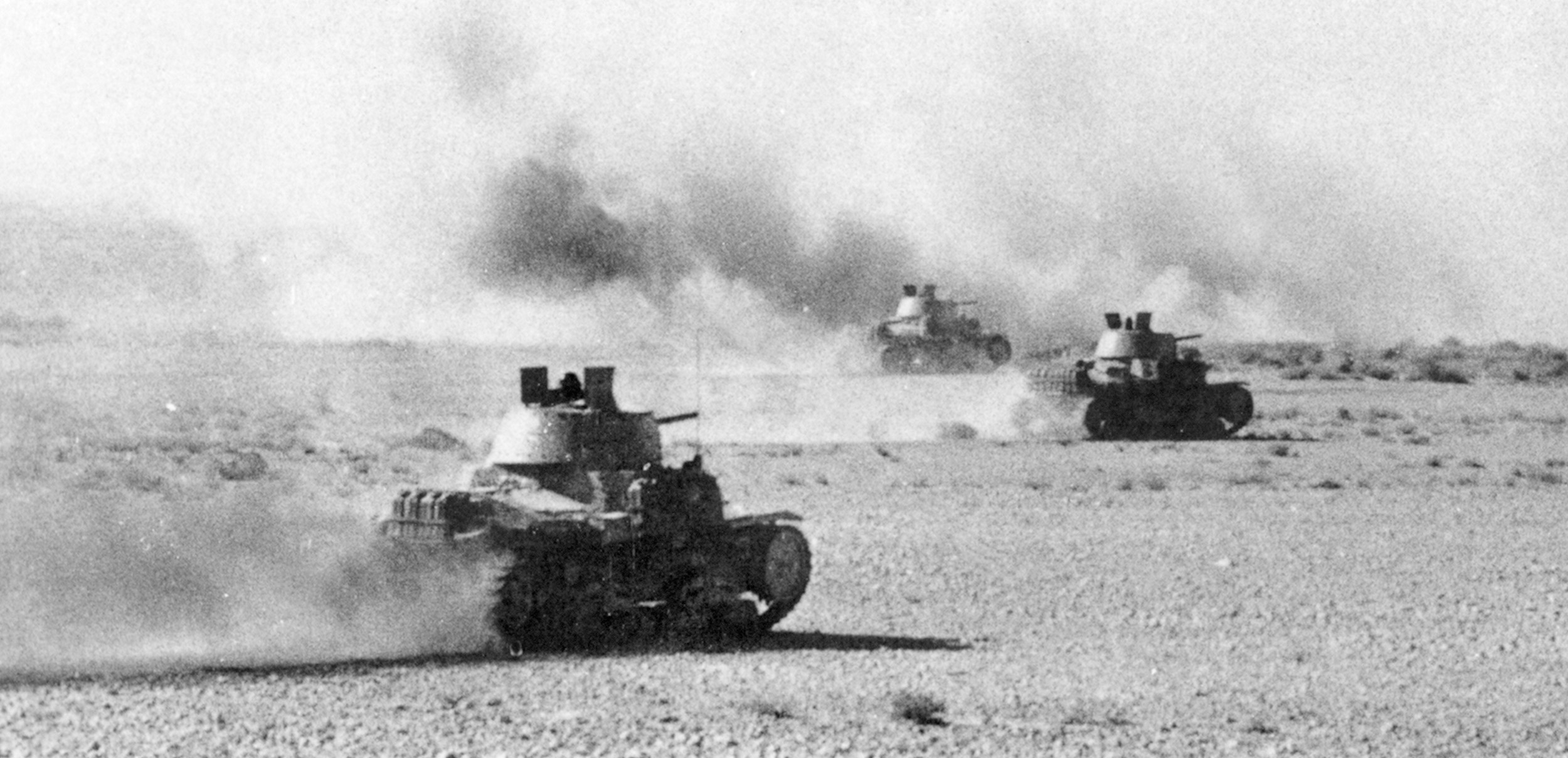 Badly outclassed, Italian tanks charge toward British guns in one of many desperate but futile counterattacks at Beda Fomm. During Operation Compass, Italian armor proved no match for British firepower and tactics.