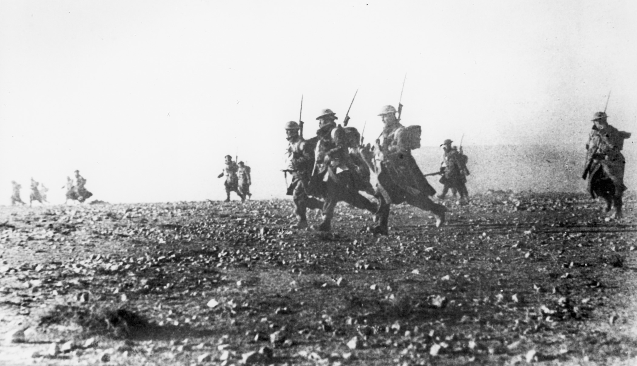 During their advance against Italian positions at Bardia, heavily equipped Australian soldiers advance rapidly across open ground. The Italians lost some 30,000 prisoners in a matter of hours.