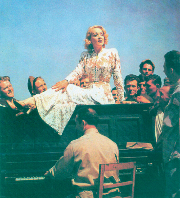 Entertainer Marlene Dietrich strikes a pose as she sings for Allied soldiers.