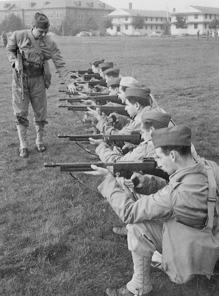 During training at Mitchel Field, New York, airmen learn the characteristics of the Thompson submachine gun. Here, they are “dry firing” as an instructor offers advice.