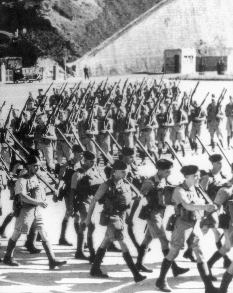 After landing in Hong Kong in November 1941, Canadian troops march to join the garrison.
