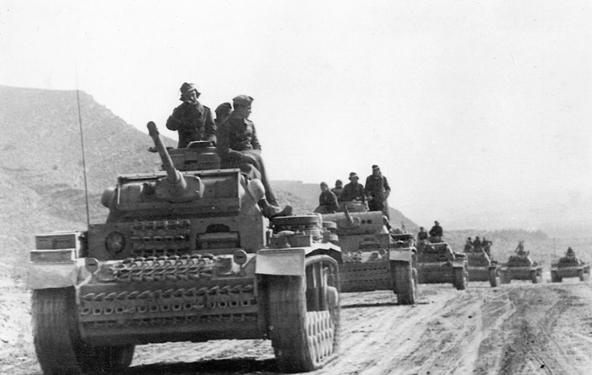A column of German Mark III tanks rolls along a desert road. Hitler initially sent Wehrmacht units to North Africa to bolster his faltering ally, fascist Italy.