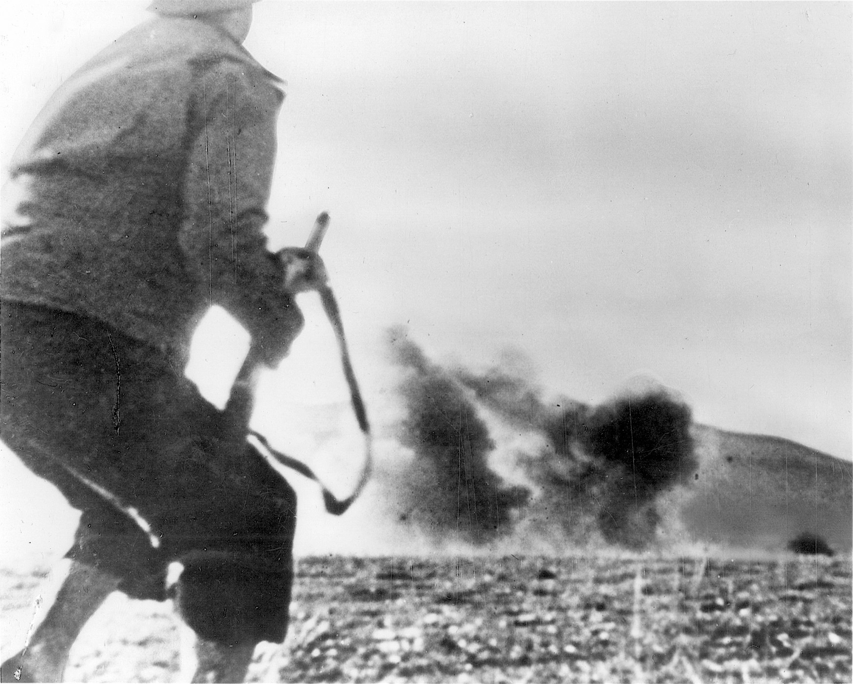 The blast of a German bomb rattles a GI on the move.