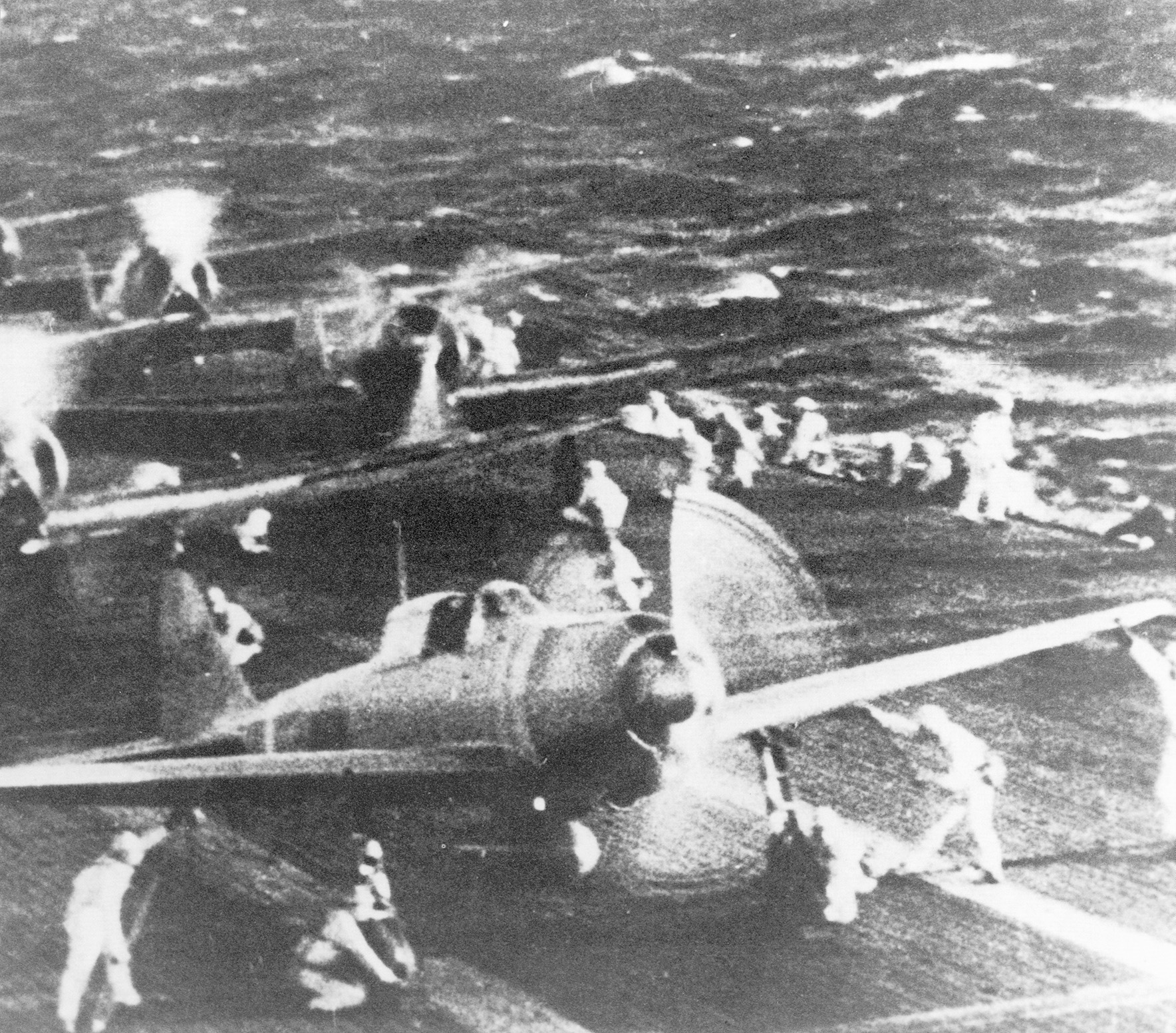 Japanese airmen ready their bombers and torpedo planes for the attack. 