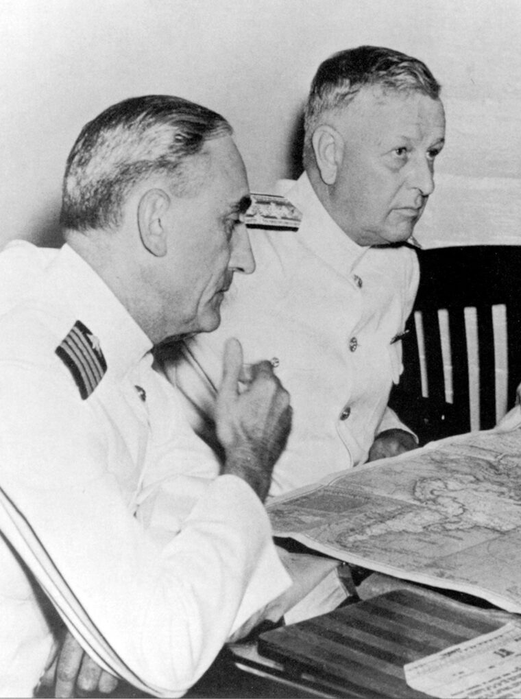 Admiral H.E. Kimmel at right confers over maps with his operations officer, Captain Walter DeLany, on December 2.