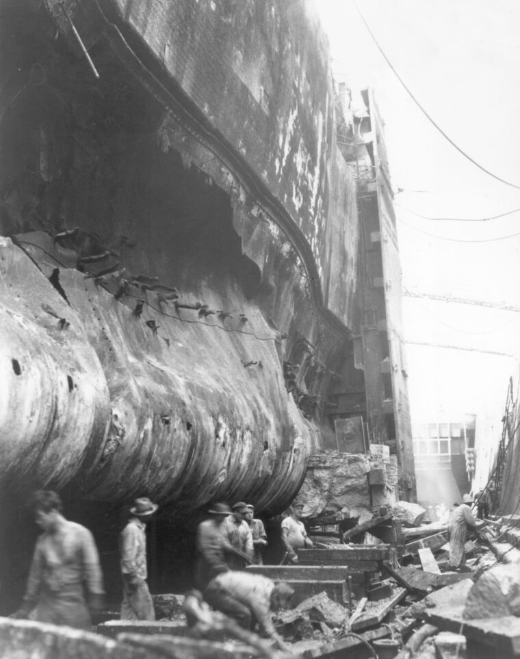In dry dock, the hull of the battleship West Virginia shows the gaping hole blasted by a Japanese torpedo during the Pearl Harbor attack.