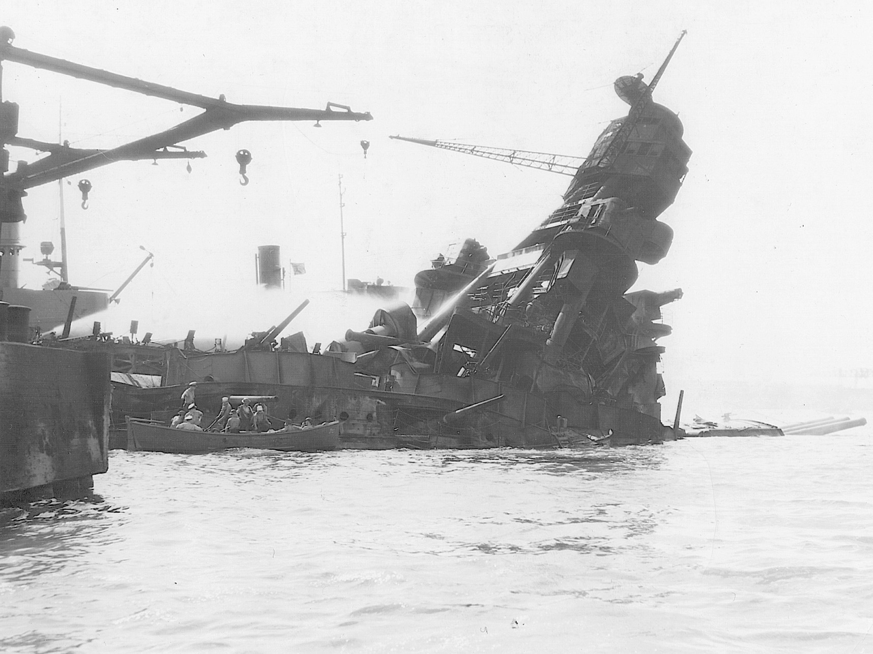 The twisted superstructure of the battleship Arizona shows the effects of the giant blast that killed more that 1,100 members of her crew.