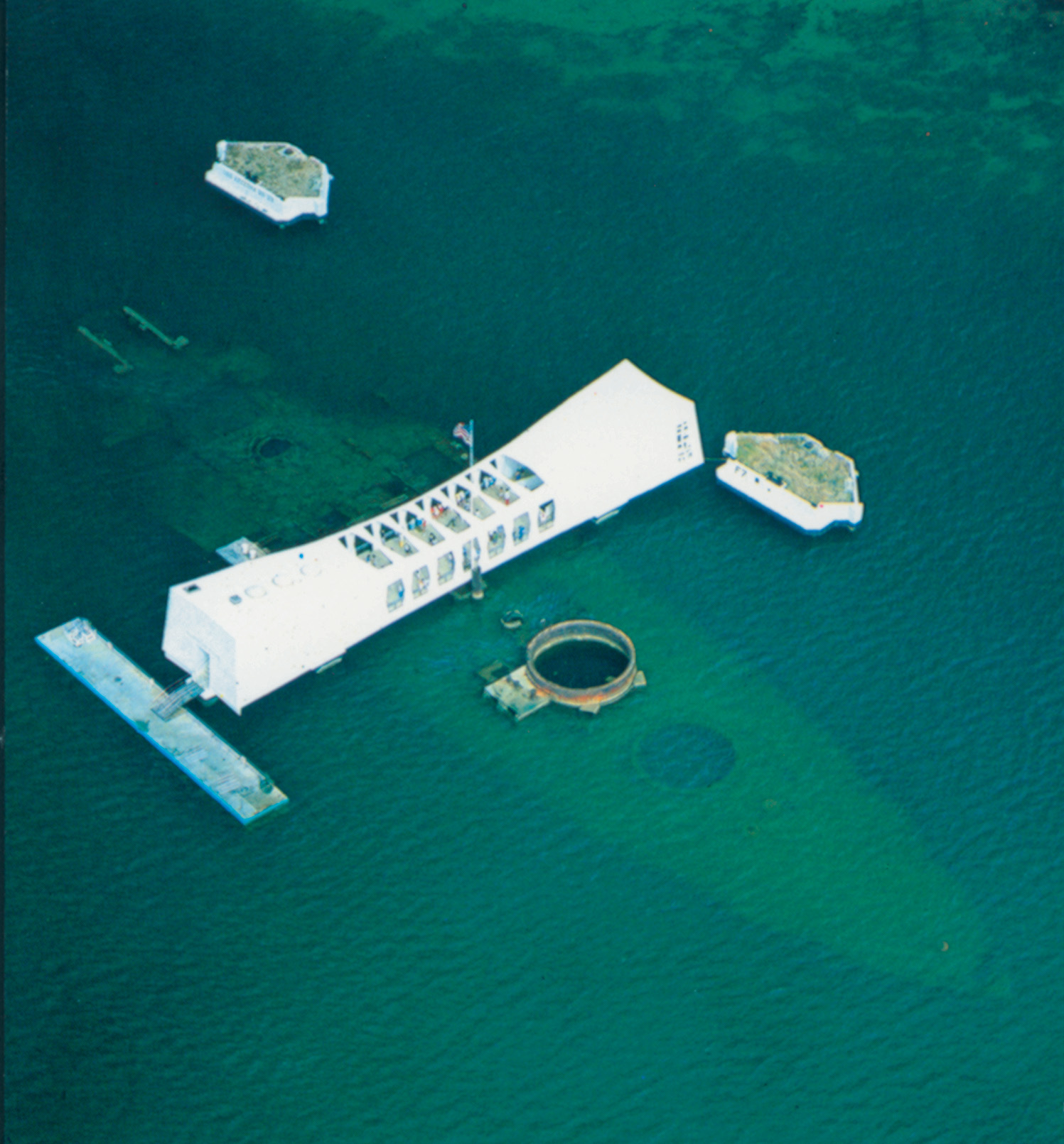 The Arizona Memorial sits astride the sunken vessel where hundreds of her crew are entombed.