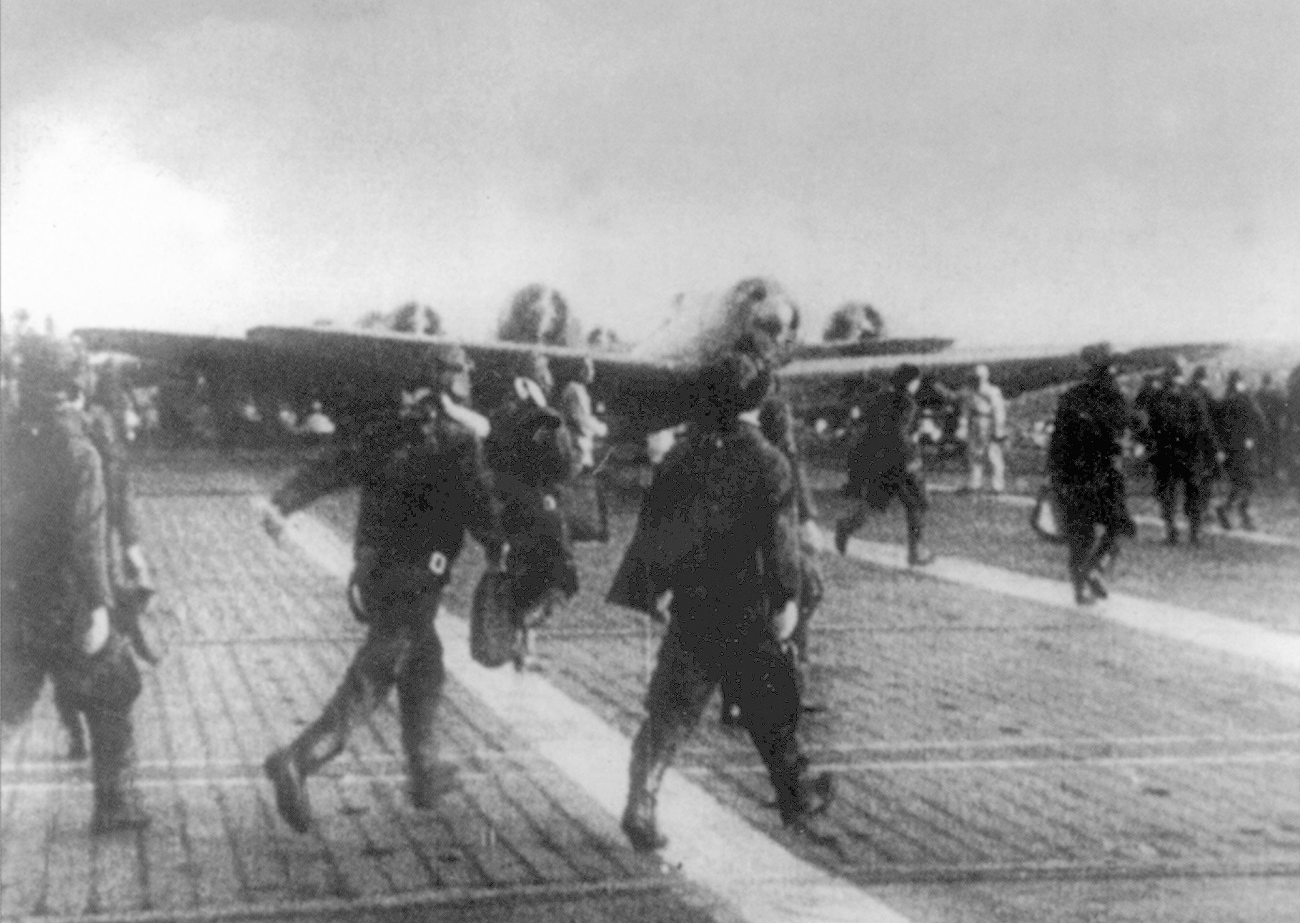 Japanese airmen take to their planes for the attack on Pearl Harbor. The Japanese fleet sailed through storm and fog across the North Pacific and away from the normal sea lanes to arrive undetected two hundred miles away from Hawaii on the morning of December 7.