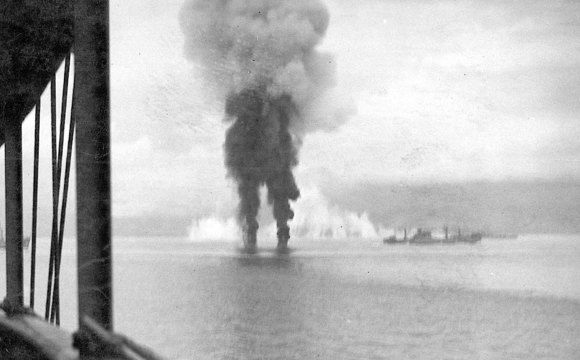 Smoke rises from the crash sites of two Japanese planes. In the distance are the Libra and the Betelgeuse.