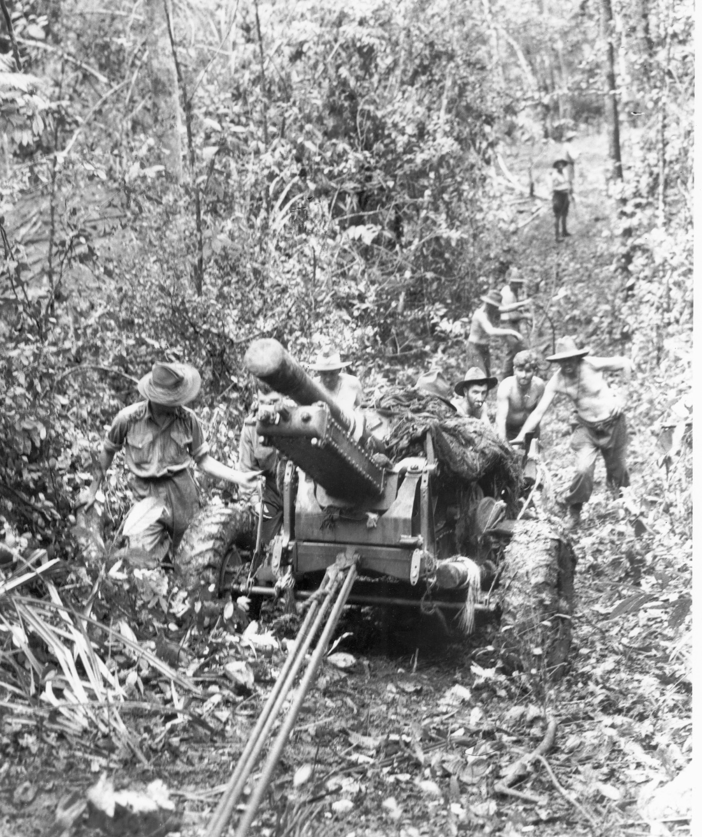 Australians haul a 25-pounder gun up a portion of the track.