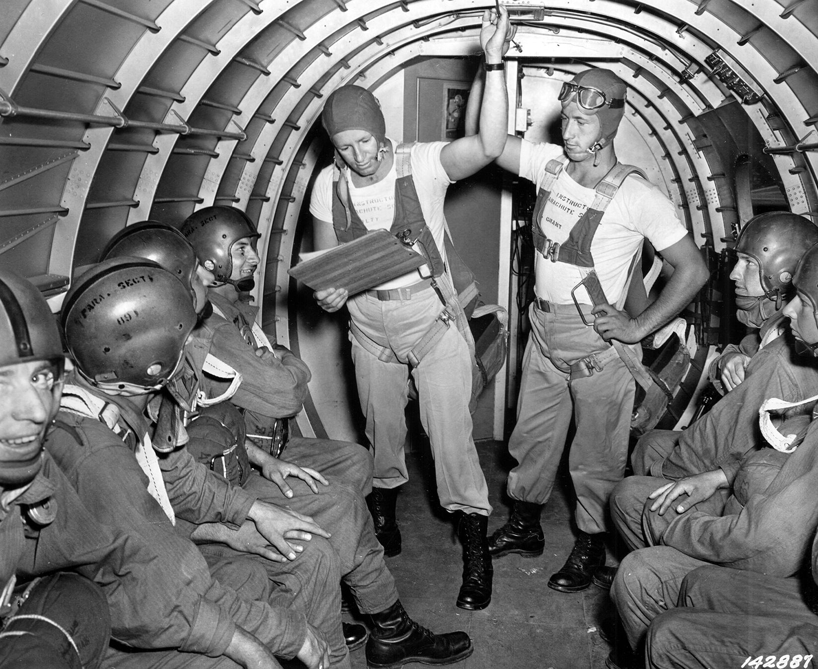 After boarding their transport plane for exercises in July 1942, paratroopers listen as the jump master calls their names. A pre-jump roll call was required for all airborne parachute exercises.