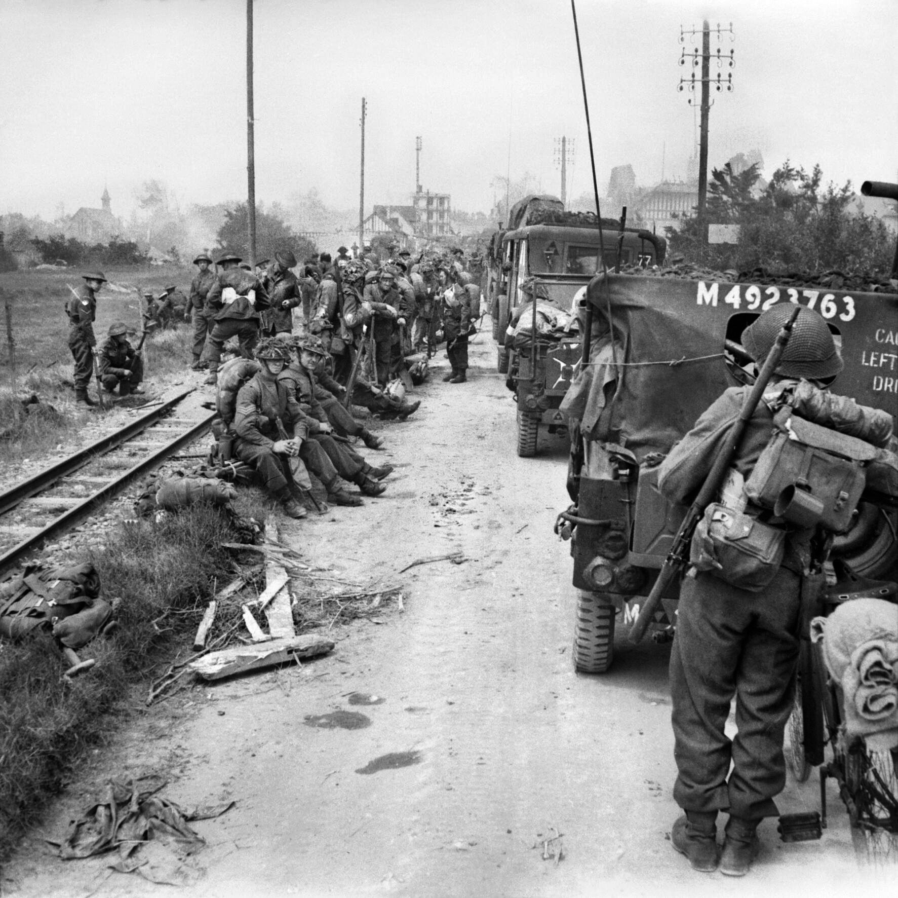 Soldiers of the British 3rd Infantry Division wait alongside their vehicles for orders to move inland on D-Day. Field Marshal Bernard Montgomery was overly optimistic in his assessment that Caen could be taken within hours of landing, and a difficult fight for control of the communications center lay ahead.