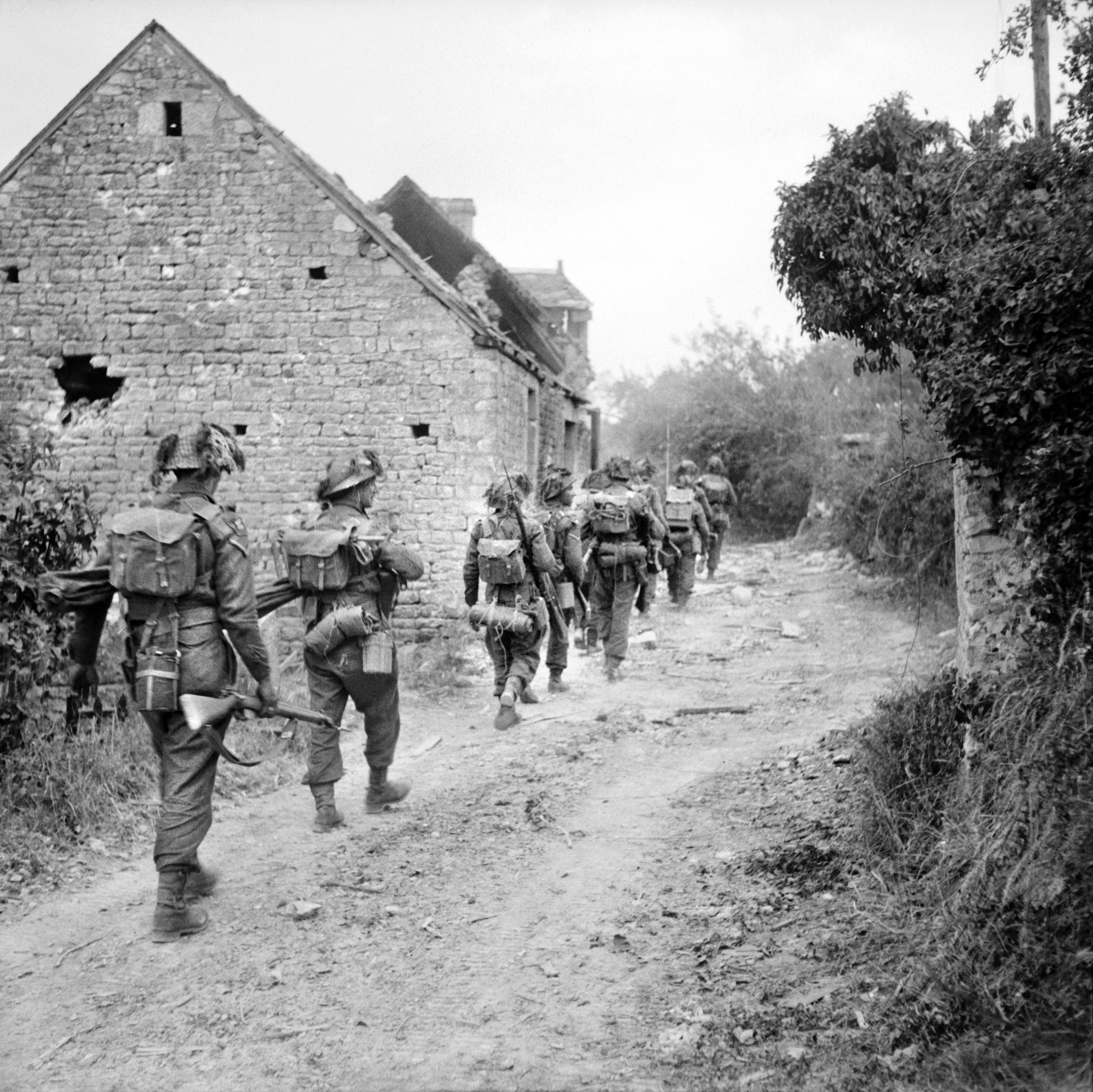 British soldiers of the York and Lancaster Regiment move warily through the French village of Fontenoy-le-Pesnel in Normandy on June 25, 1944. The fight for Caen was long and arduous during the Normandy campaign.