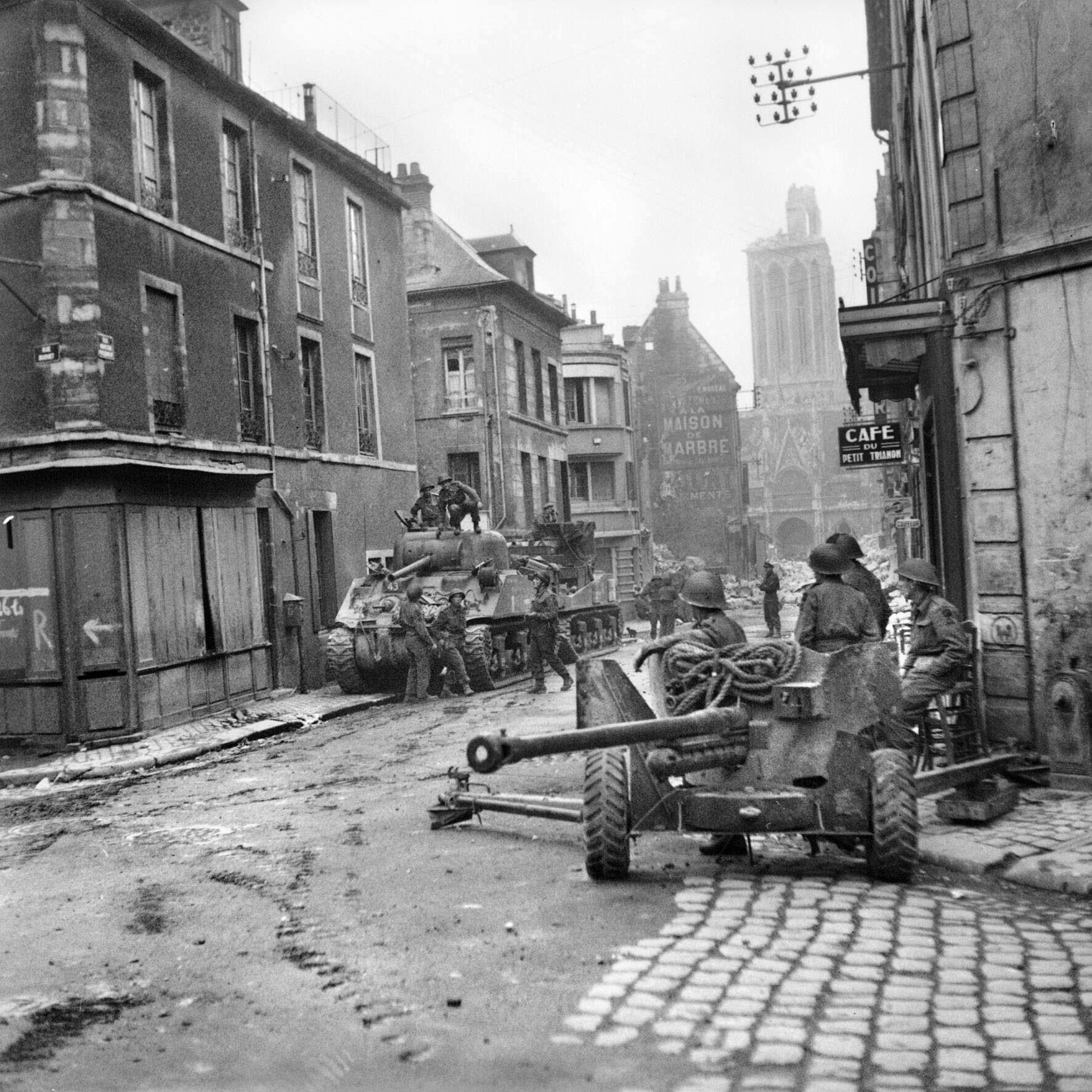 Sherman tanks and a 6-pounder anti-tank gun occupy a city street in Caen on July 10, 1944. After heavy bombing and numerous ground attacks, Caen finally fell to Allied forces weeks after D-Day.