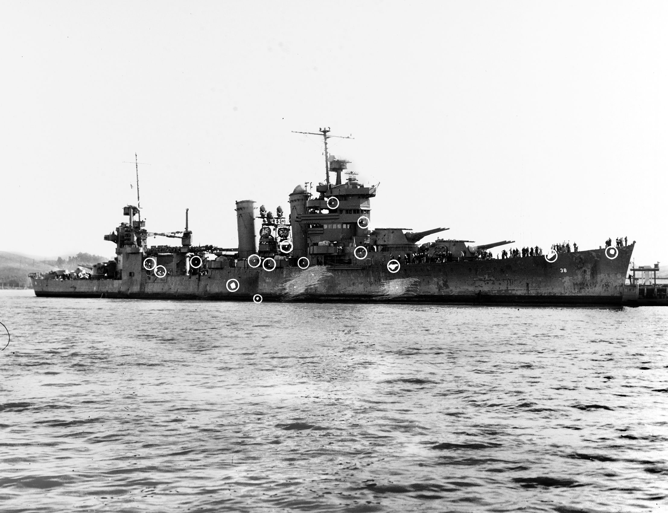 After returning to Mare Island Naval Yard for repairs following the Naval Battle of Guadalcanal, the heavy cruiser USS San Francisco is shown with circles marking areas where the ship sustained battle damage. Capt. Cassin Young and Adm. Daniel Callaghan were killed during the nocturnal battle in the Solomons.