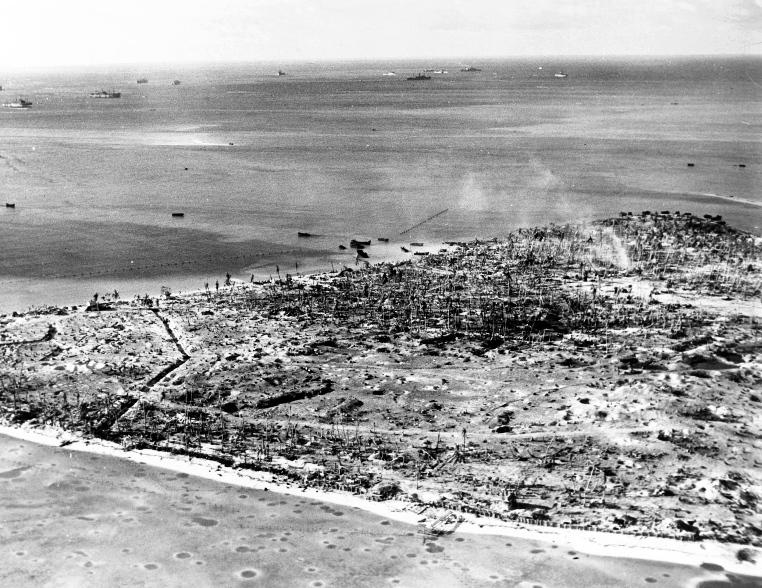 Following the capture of Betio by U.S. Marines in November 1943, this aerial view of the islet's western shore depicts the shell holes and other evidence of the vicious fight for control of Tarawa Atoll. The victims of the mass execution that occurred in at Betio in October 1942 are believed to have been buried in the area marked in red.