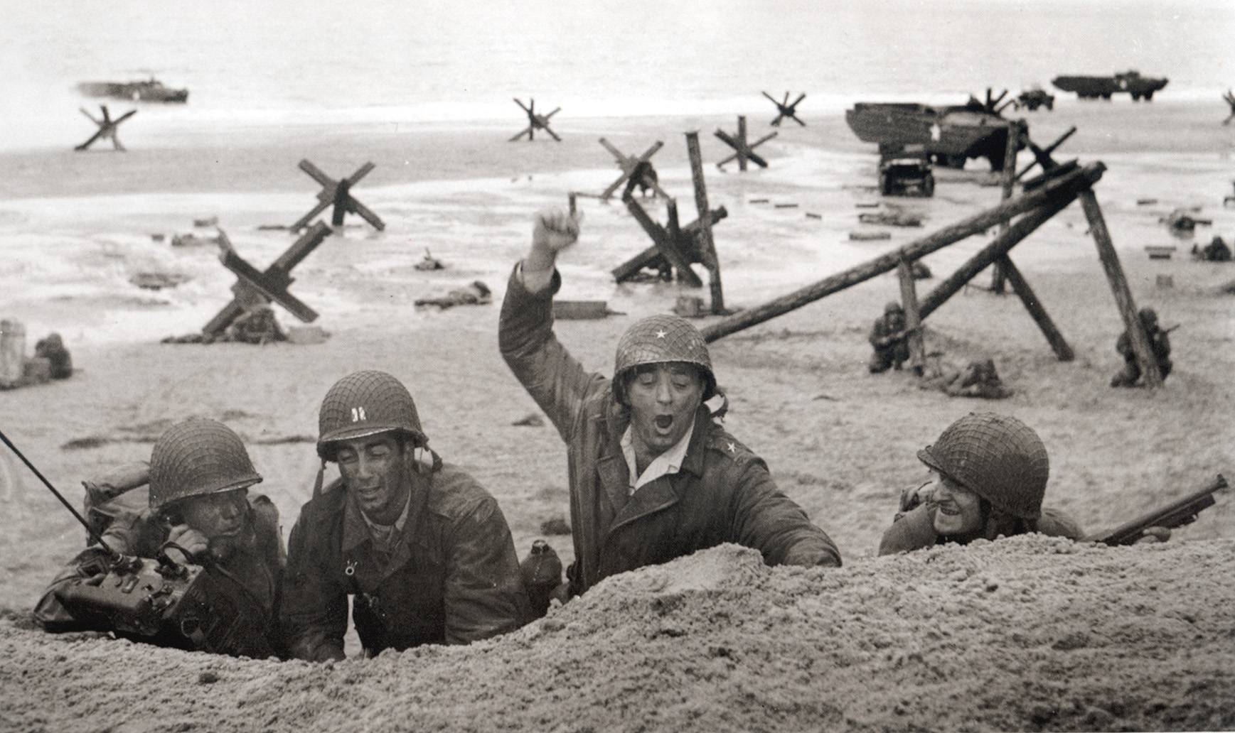 Brigadier General Norman Cota (Robert Mitchum) leads his men onto the beaches at Normandy in The Longest Day.