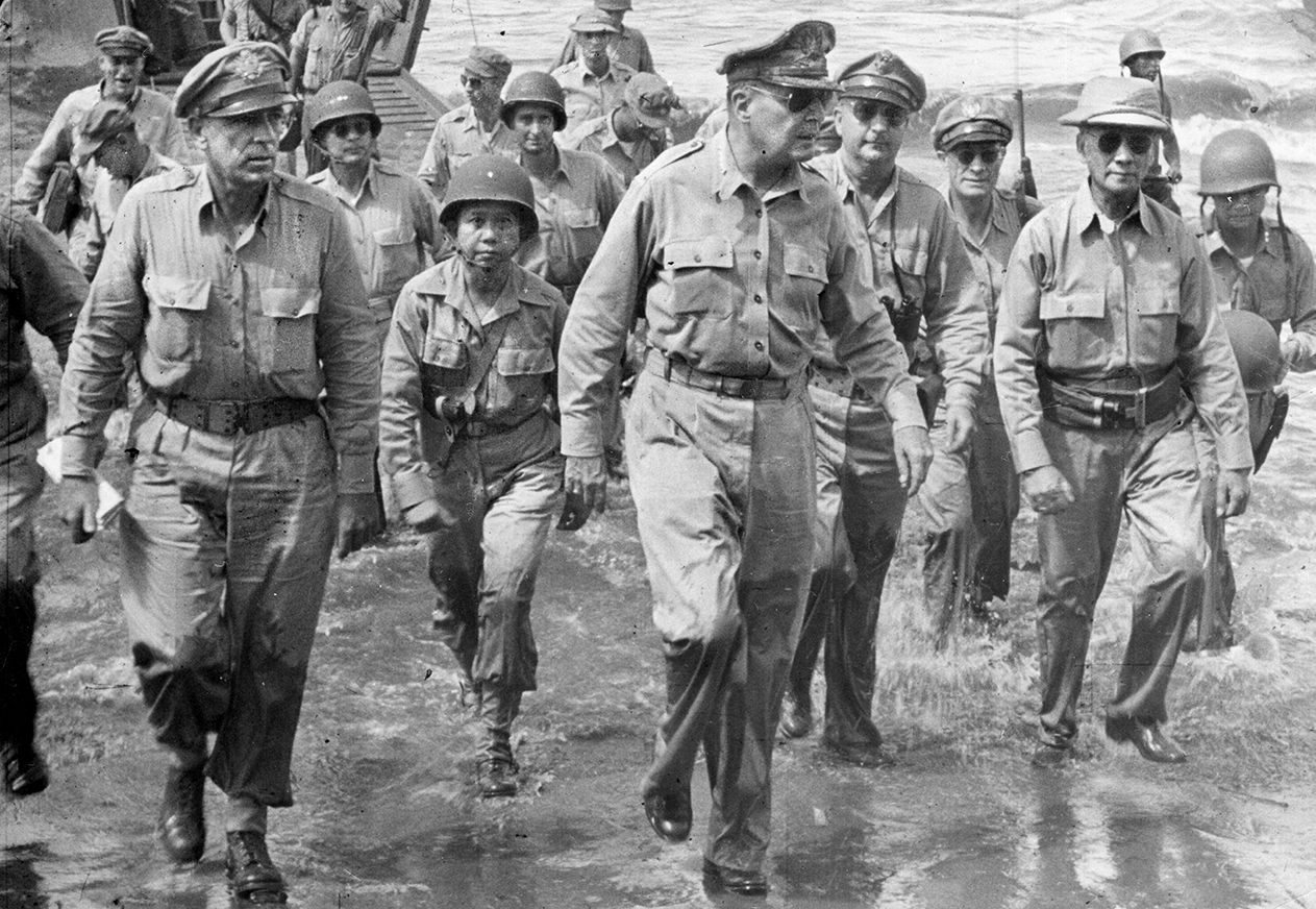 U.S. General Douglas MacArthur wades ashore at Leyte Island in October, 1944, fulfilling his promise to return to the Philippines.