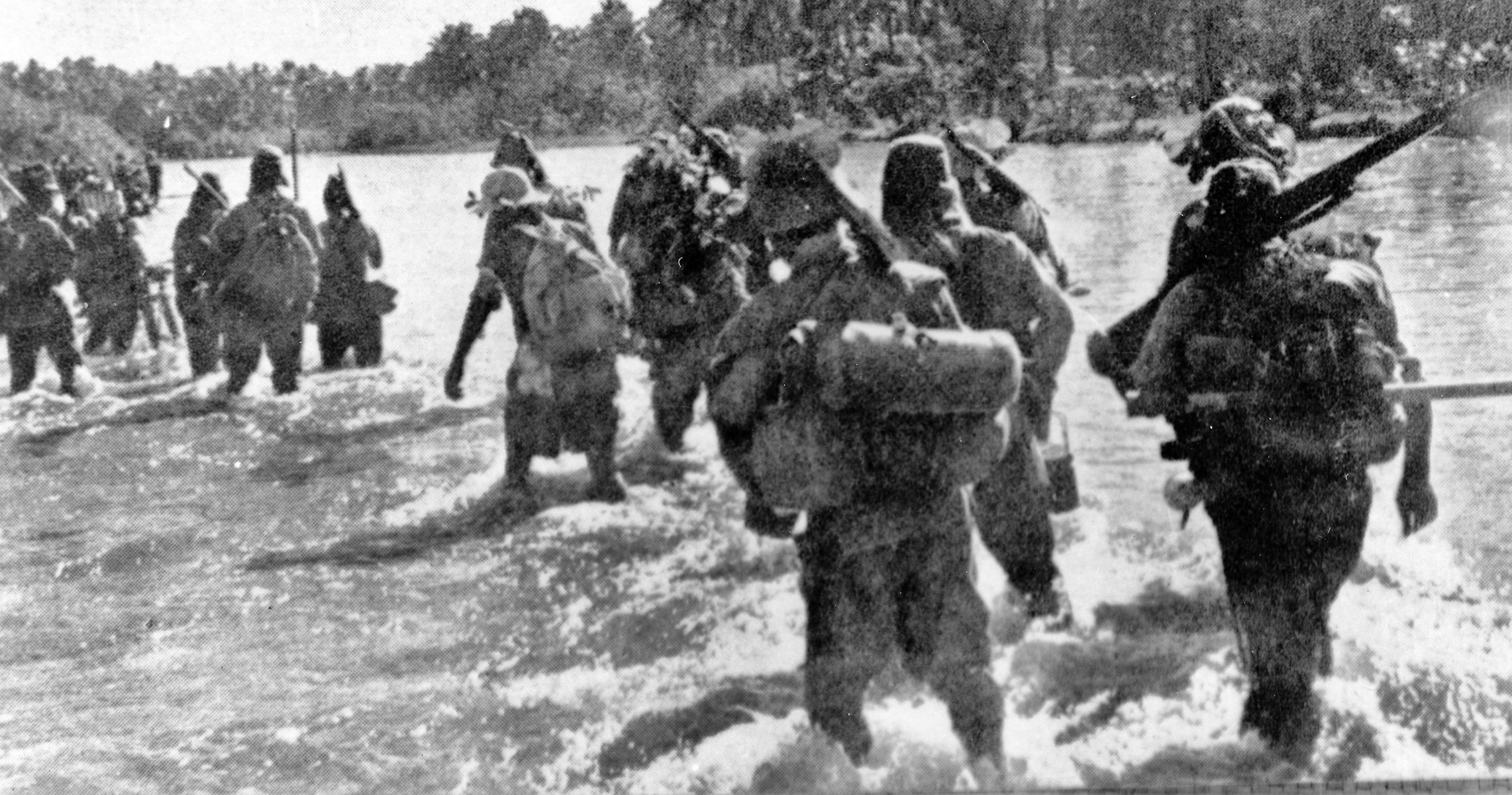 Japanese troops ford a river in the Philippines in this captured war photograph. The 20,000 Japanese troops defending  Leyte—mostly raw draftees—lacked food, ammuntion and equipment.