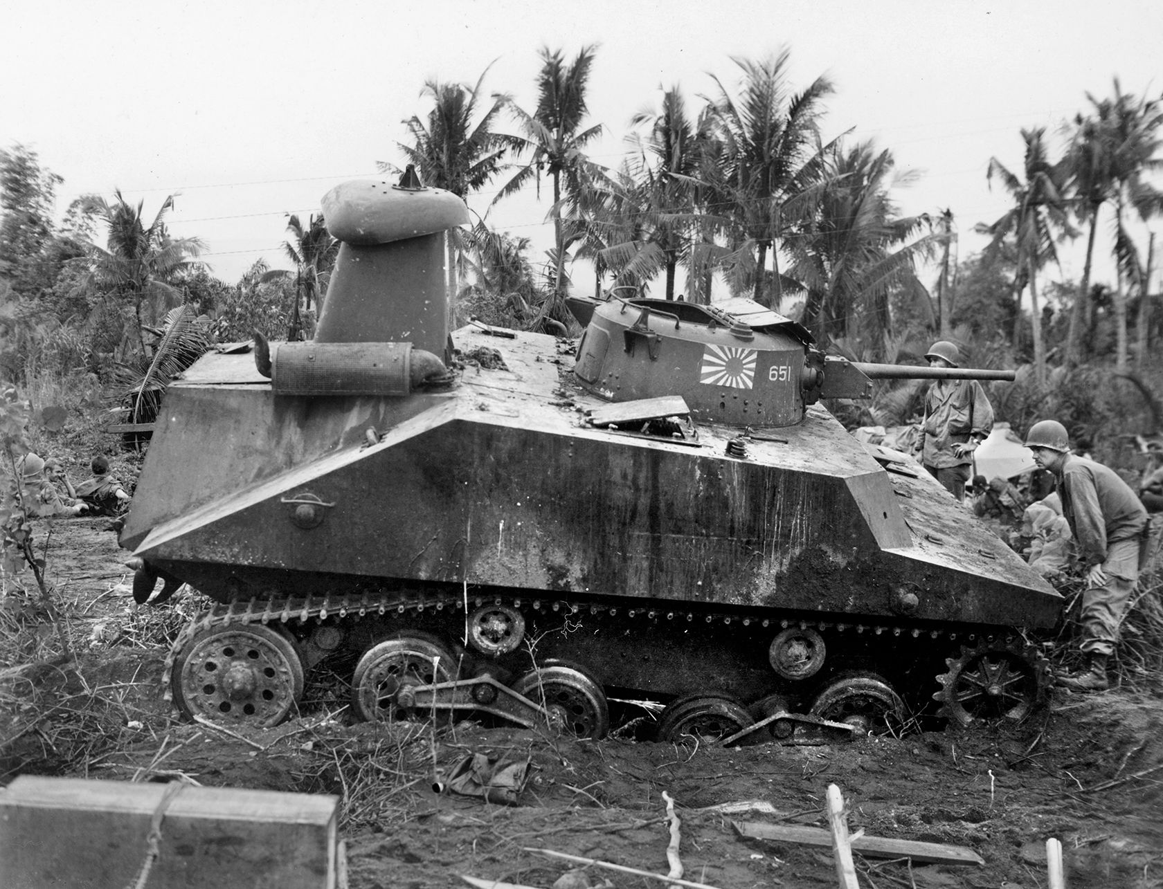 U.S. soldiers inspect a knocked-out Japanese Type 2 KA-MI amphibious tank—without its flotation sections. First deployed by the Japanese at Guadalcanal, most of the KA-MI tanks used in support the 101st SNLF (Special Naval Landing Force) at Ormoc Gulf in late 1944 were destroyed. 