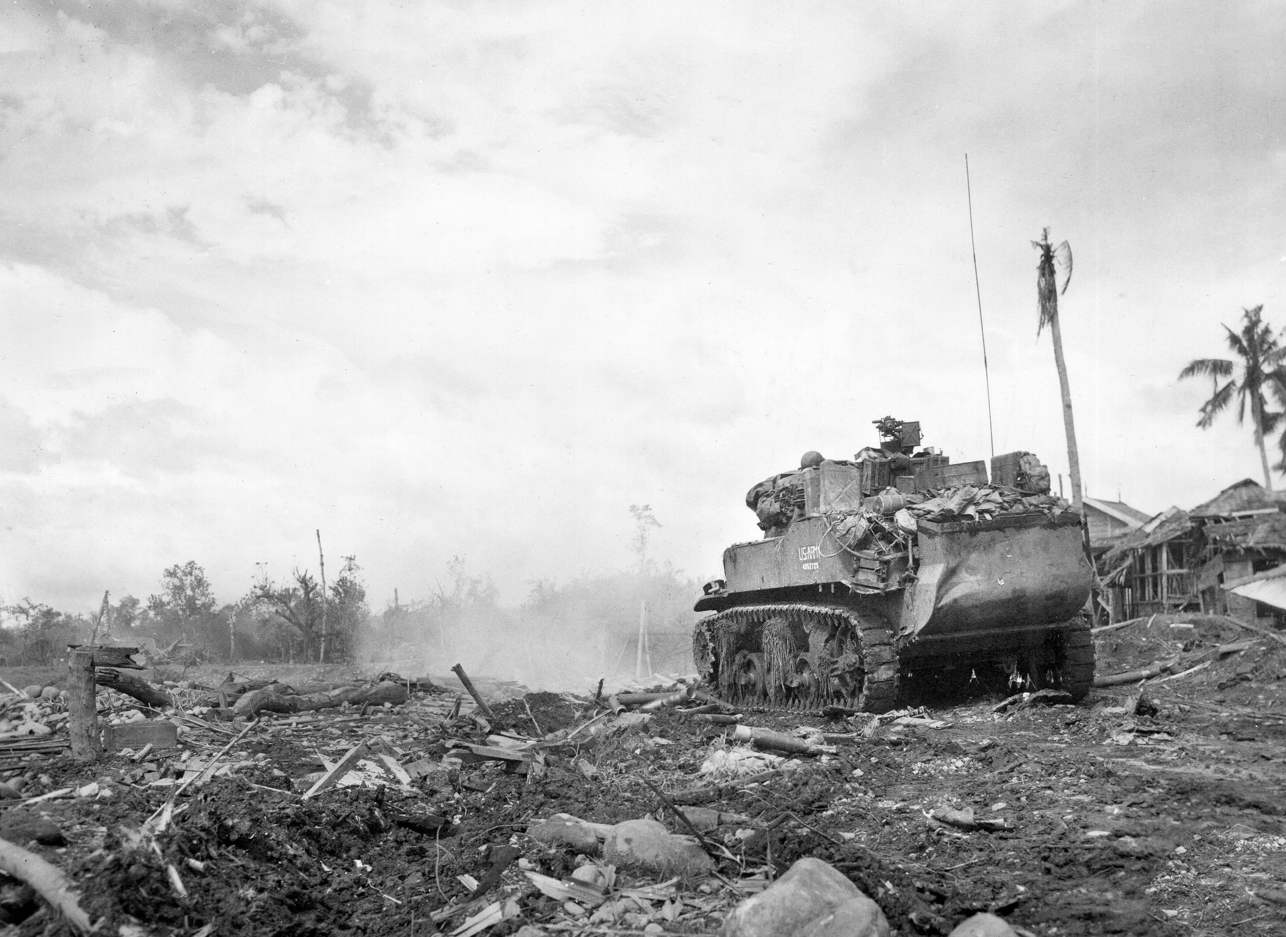 A U.S. Army M8 self-propelled gun fires on a Japanese pillbox in support of the 77th Infantry Division fighting in the Ormoc Valley on west Leyte Island in the Philippines. Equipped with snorkels during landings, the Howitzer Motor Carriage M8 could land in shallow water and proved effective in the Pacific War.