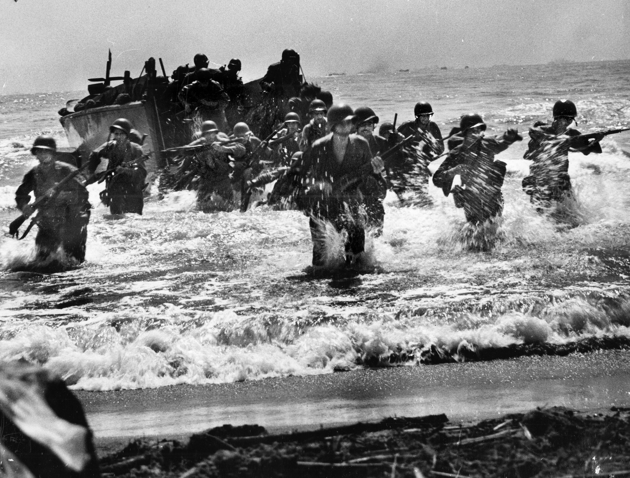 A Coast Guard-Manned LST unloads Sixth Army Division troops in an early wave of the amphibious landing at Leyte Island, Philippines, on October 20, 1944.