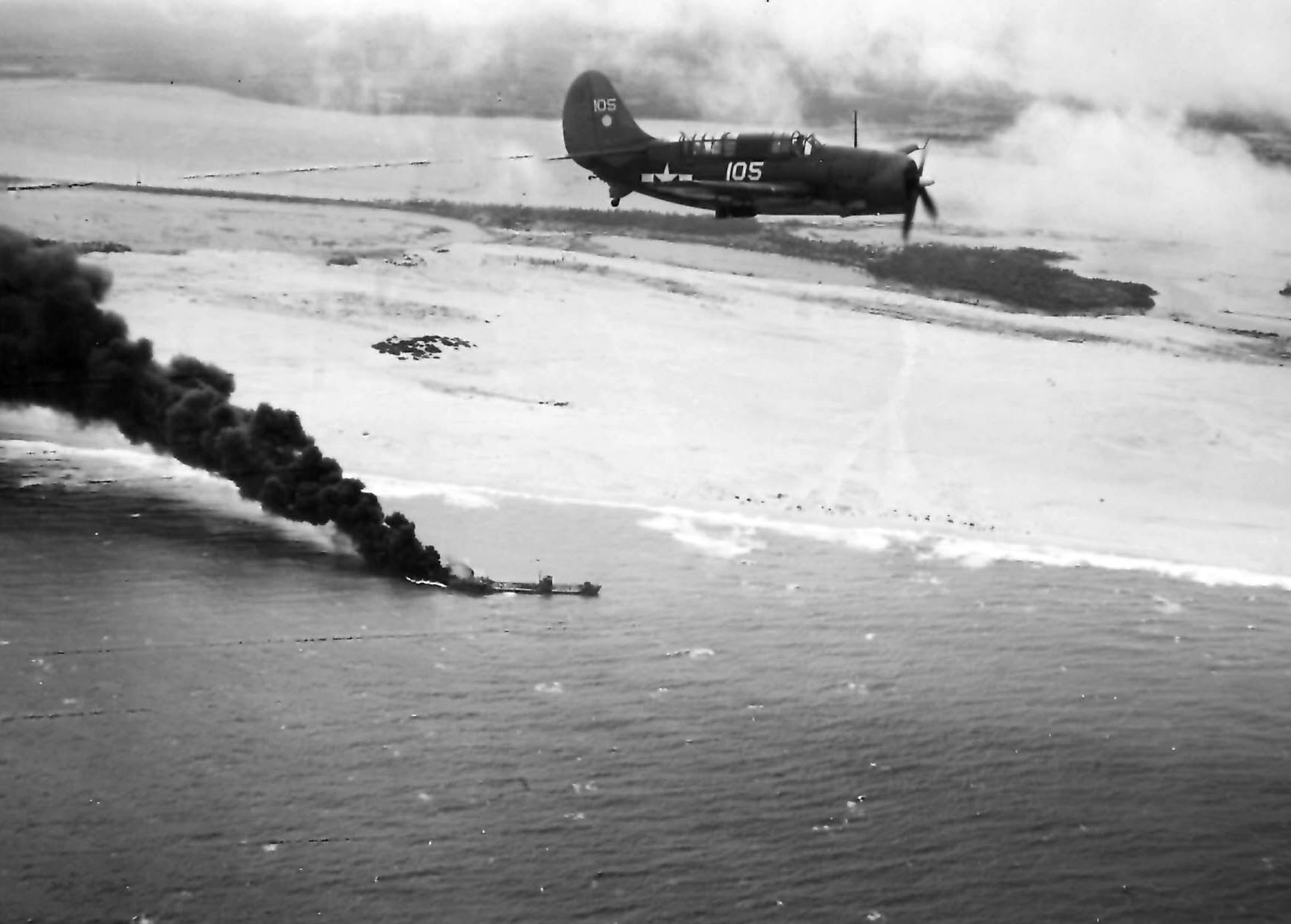 A Navy Helldiver from the carrier USS Hornet above a burning Japanese tanker. Navy fighters and other planes sank 80 percent of the troop transport and supply ships sent to reinforce Japanese forces on Leyte Island in the Philippines.