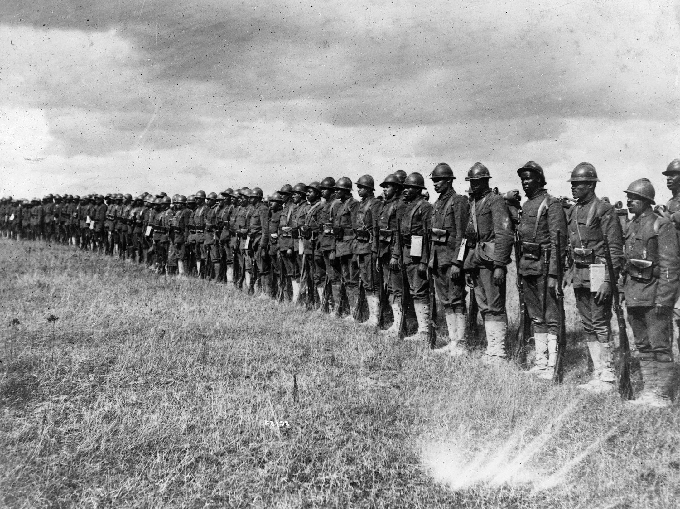 Men of the 15th Infantry Regiment, New York National Guard, photographed in France, with the French helmets issued to them when the unit was transferred to the French 16th Division. They were later issued the standard American Brodie helmets. 