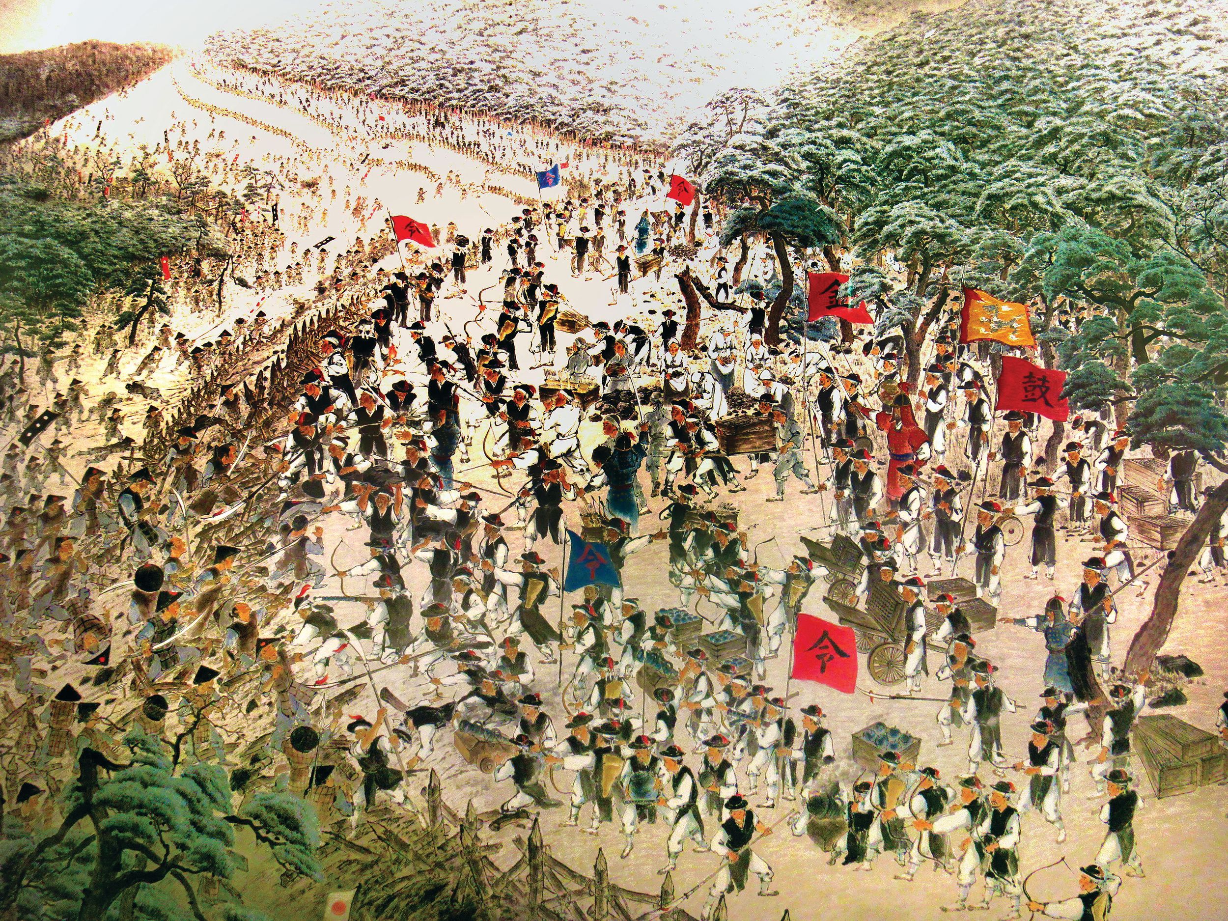 In this Korean painting of the Japanese attack at Haengju, two Korean hwachas (“fire carts“) are shown to the right of center, as a wave of Japanese rush the fortress at left. The surrounding terrain, and the earthen fortress allowed the Koreans to make successful use of the hwacha.