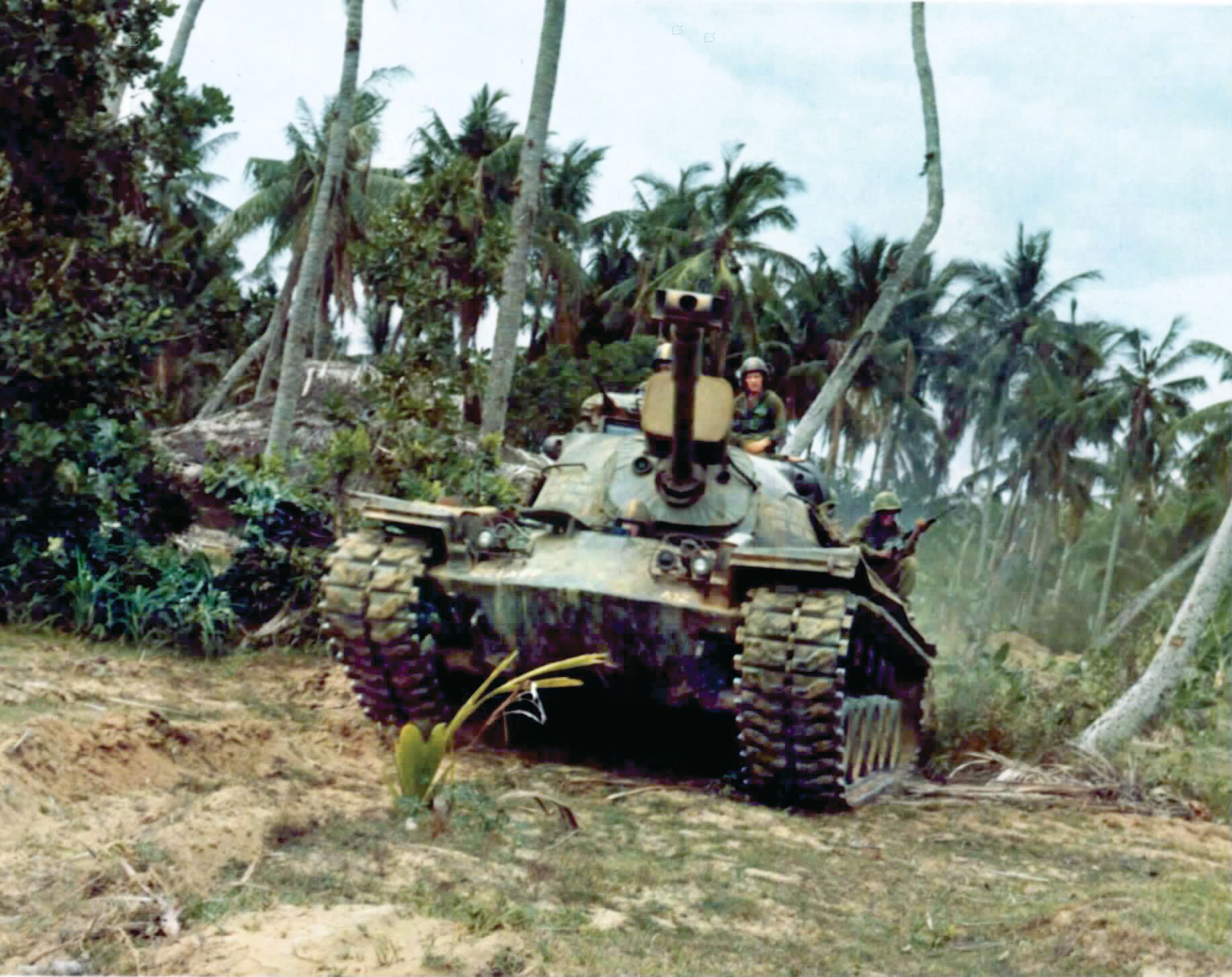 An M48A3 Patton tank from 1st Cav Division advances on a village. Tanks and M113 armored personnel carriers working alongside infantry provided needed firepower, with an occasional tank battle against the PAVAN (People’s Army of Vietnam).