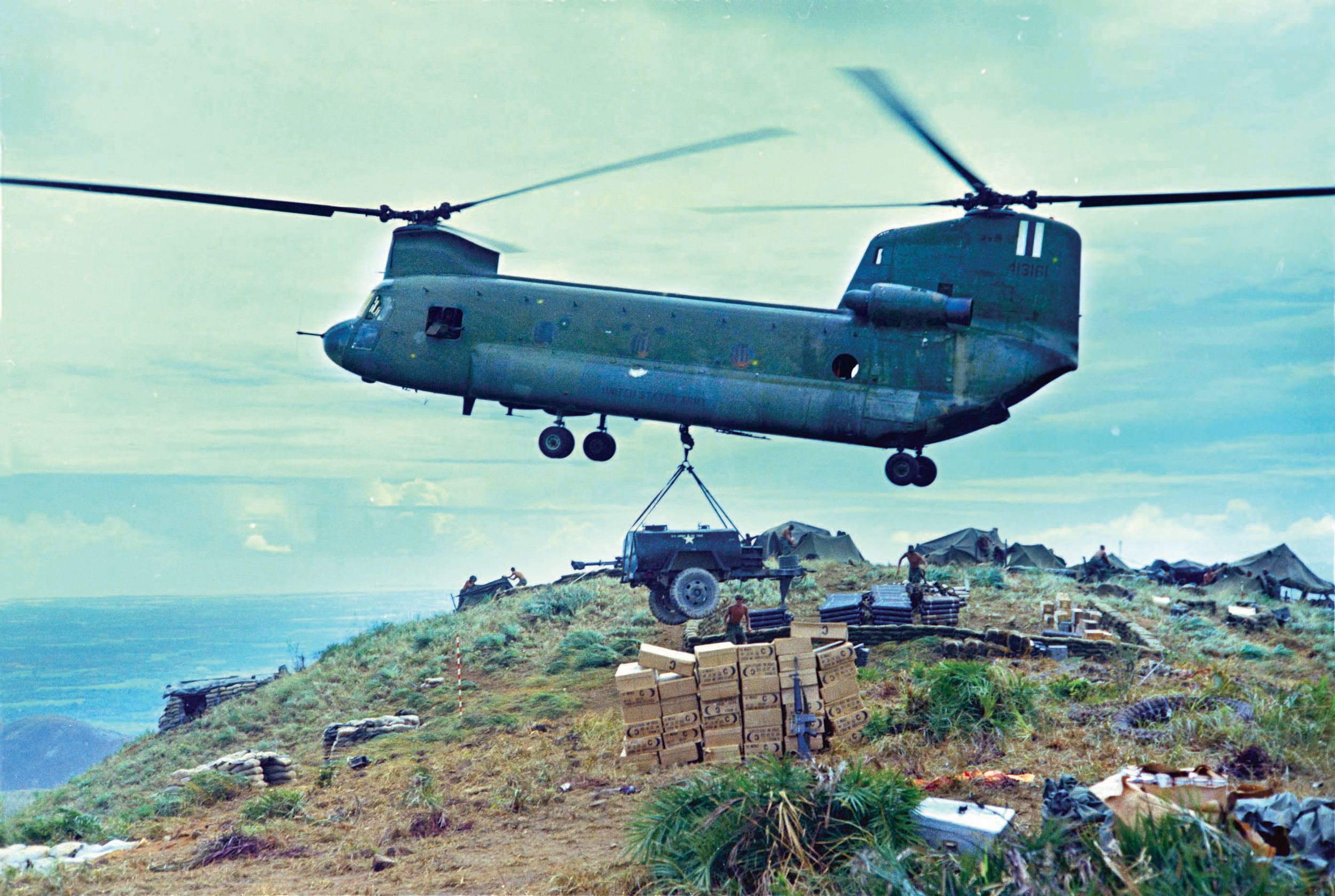 A CH-47 Chinook helicopter lowers a water trailer to soldiers of the 101st Airborne Brigade in September 1967. The 81mm Mortar Section was providing fire support for units on search and destroy missions in the Tam Ky area, as a part of Operation Wheeler.