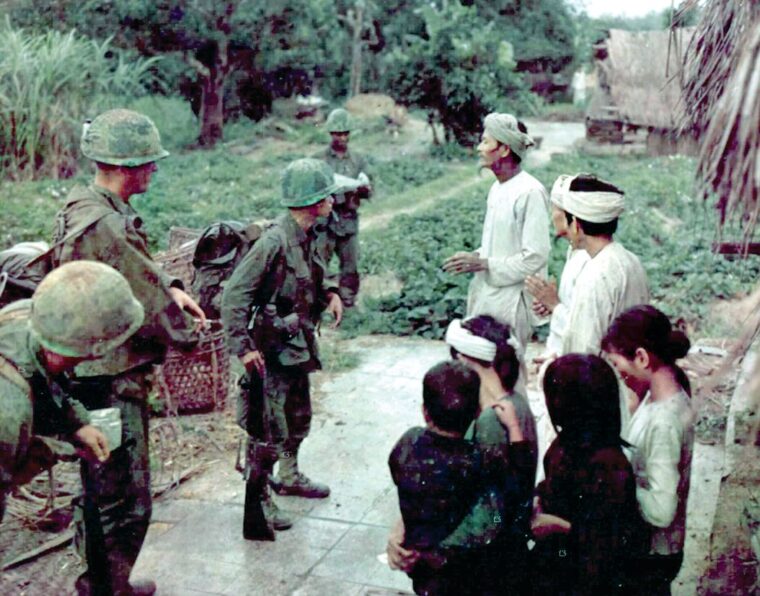 An Army of the Republic of Vietnam (ARVN) interpreter questions villagers during a search and destroy mission conducted 18 miles southwest of Da Nang during Operation Wallowa, which began in October, 1967. 