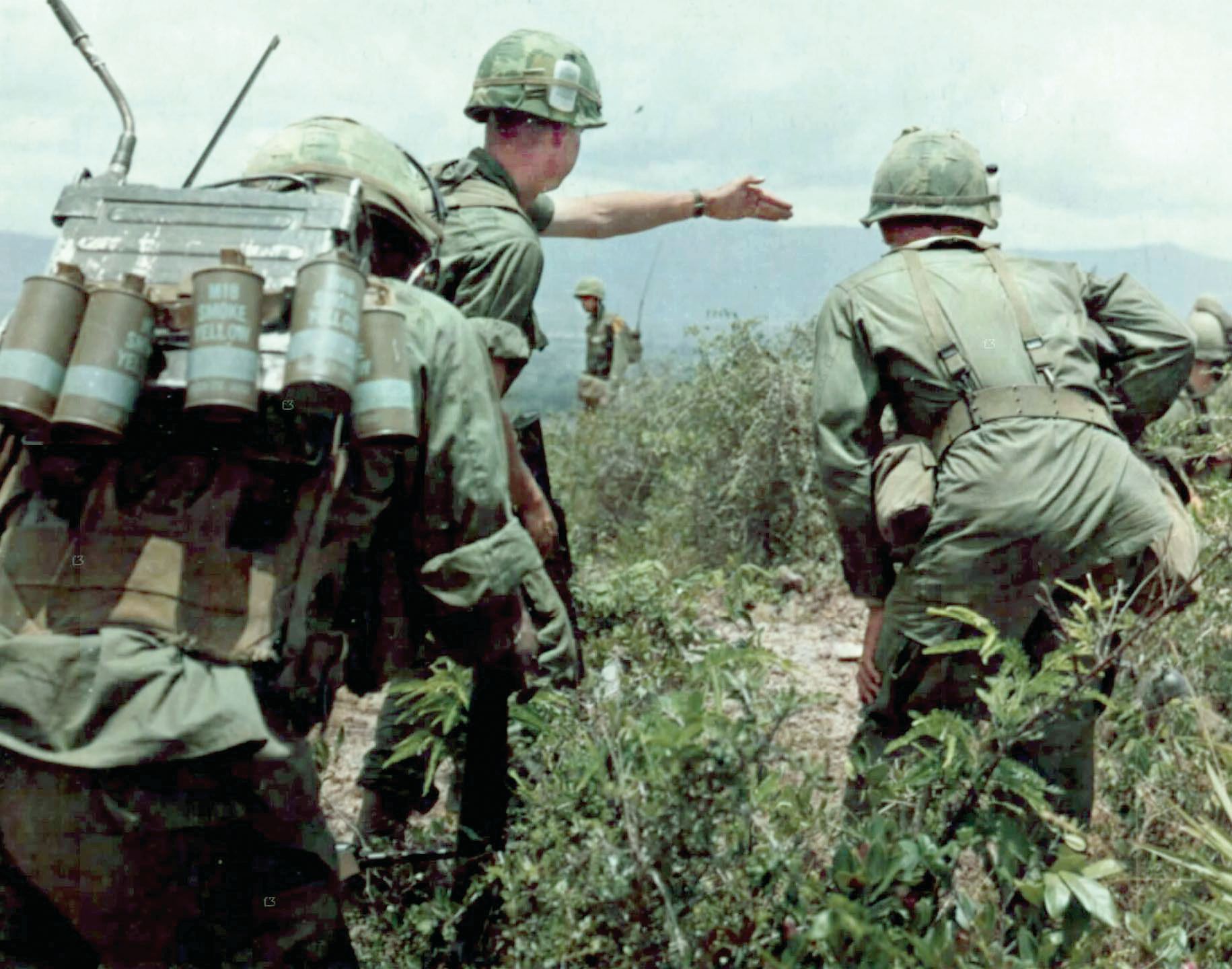 A soldier on patrol from 9th Cavalry, 1st Cavalry Division, conducting a search and destroy mission points to a suspected Vietcong outpost in September, 1967, during opening days of Operation Wheeler.