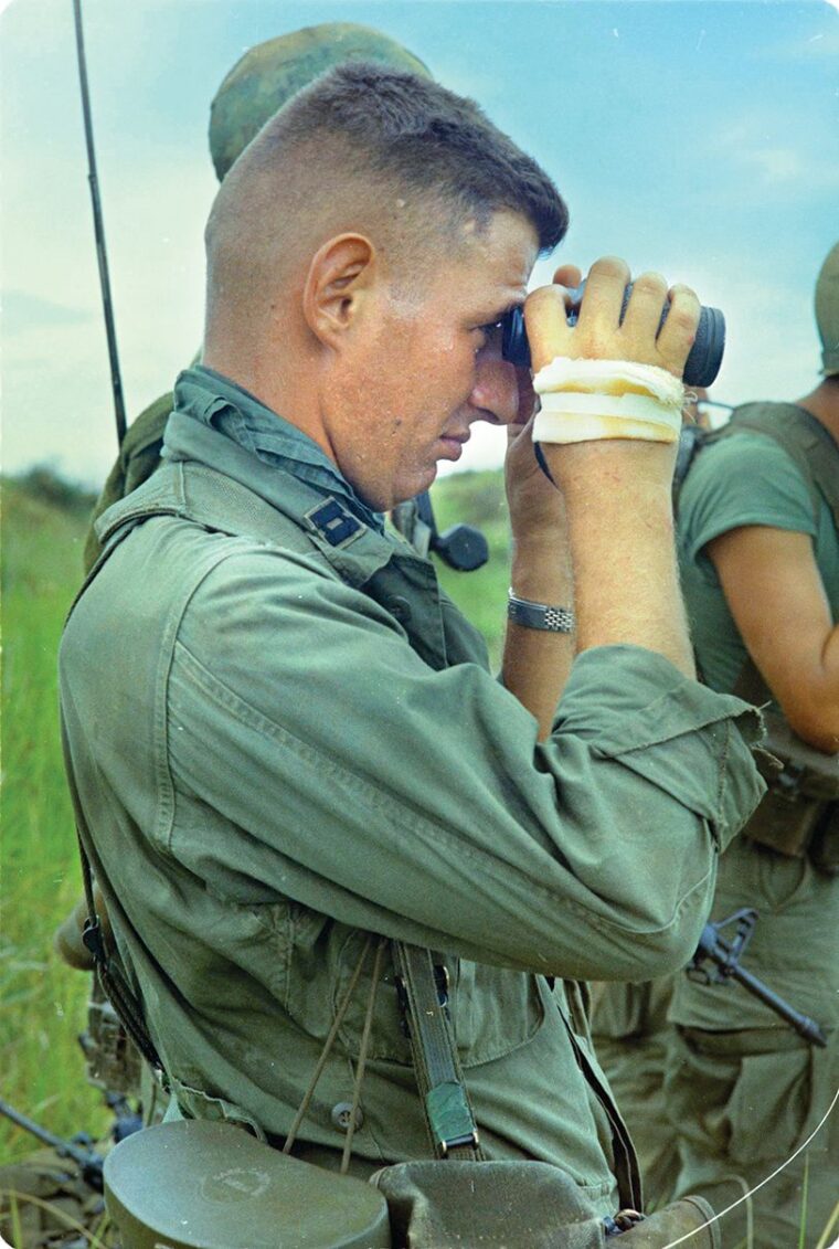 CPT Antonio Mavroudis, 327th Infantry, 101st Airborne Brigade looks for enemy targets from an observation post on a mountain top. The company was participating in Operation “Wheeler” in the Tam Ky area. CPT Mavroudis was killed in action 28 October 1967.