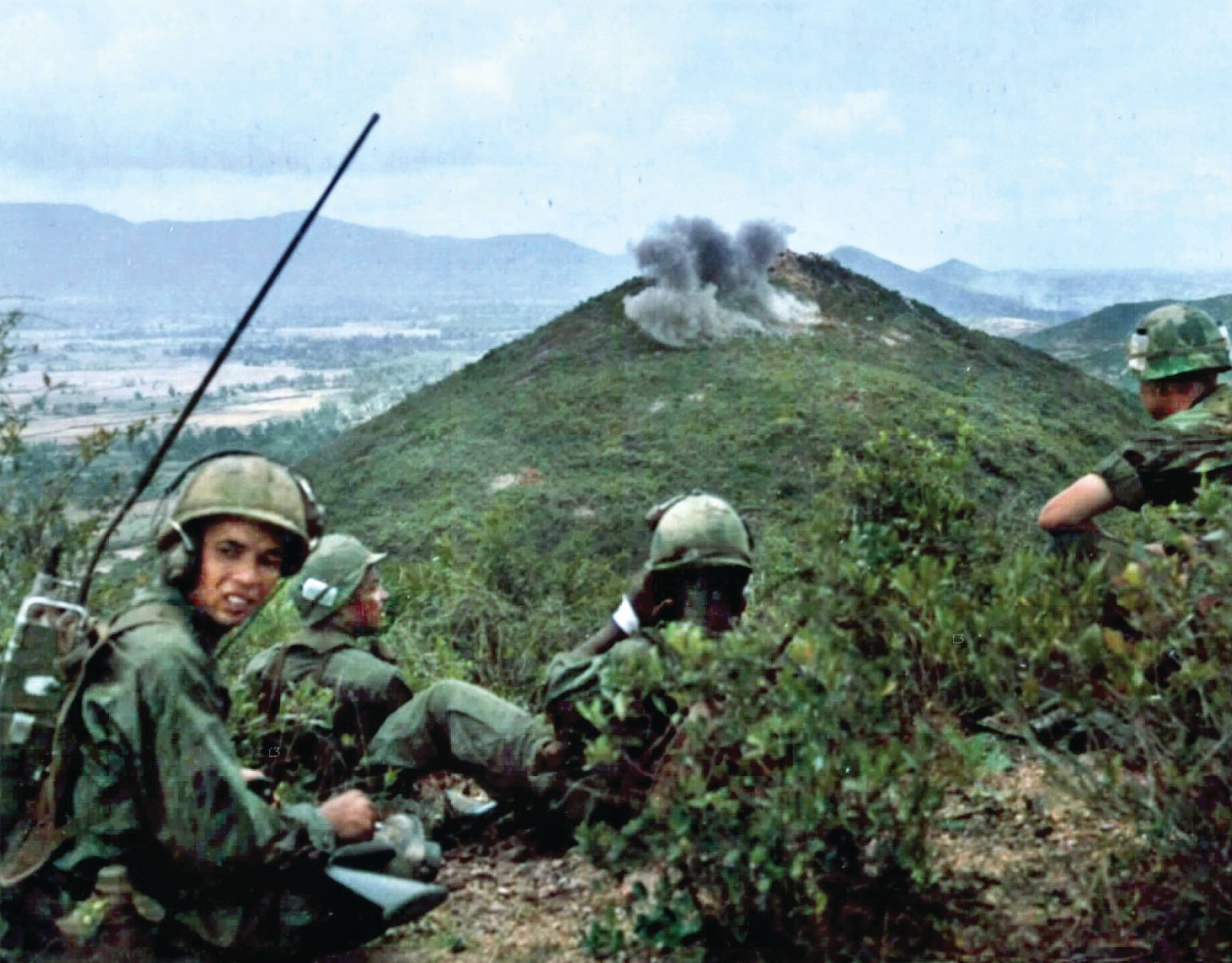 First Air Cavalry GIs observe artillery hit an enemy position during search and destroy, west of Duc Pho, Quang Ngai Province.